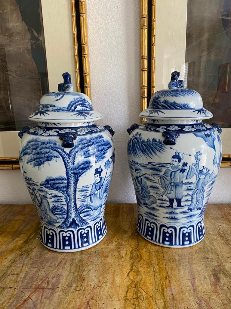 This 17th century pair of blue and white porcelain Jars with lids depicting the eight immortals in a garden scene are from the Historic BEAL HOUSE in the United Kingdom. These Chinese Jars are painted by hand having foo dogs to the top lid and foo
