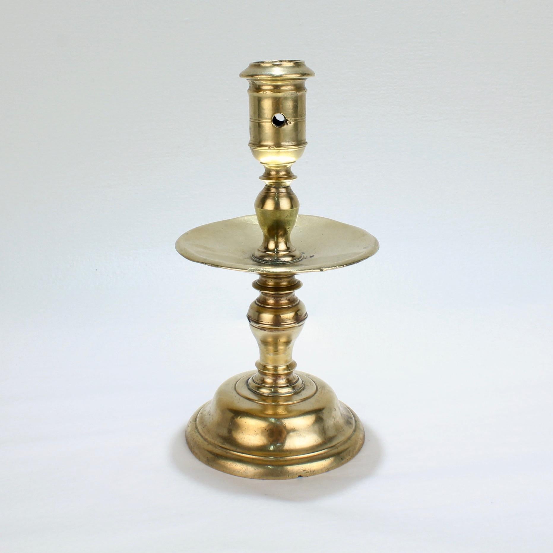A fine 17th century Dutch brass candlestick.

With elegant baluster turnings, a medial drip pan, and a hole for removing wax.

A rare model and a Fine example for any collection!

Measures: Height: ca. 8 in.

Items purchased from this dealer