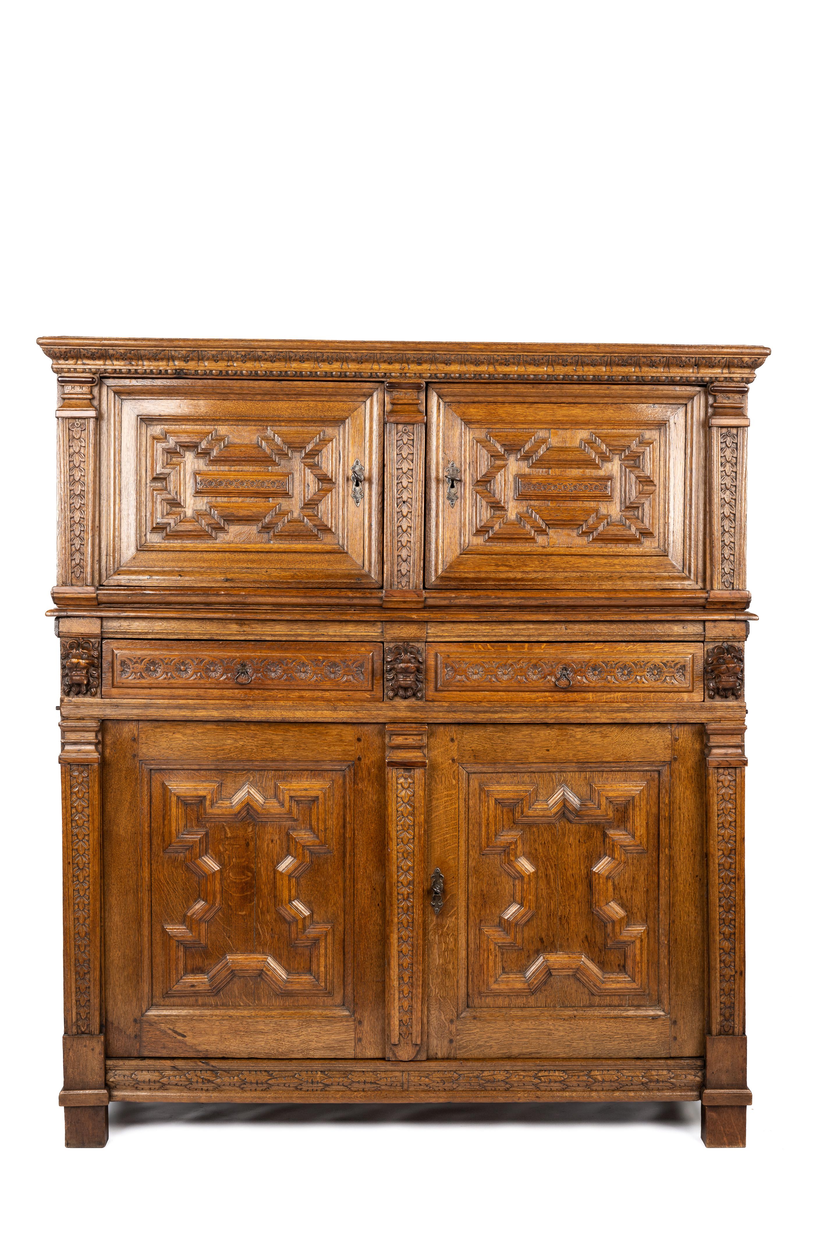 This fantastic two-piece 17th-century oak cupboard was made in Antwerp, Flanders, circa 1680. It consists of two pieces, a lower and an upper cabinet. The lower cabinet can be used without the upper cabinet and is finished accordingly. The cabinet