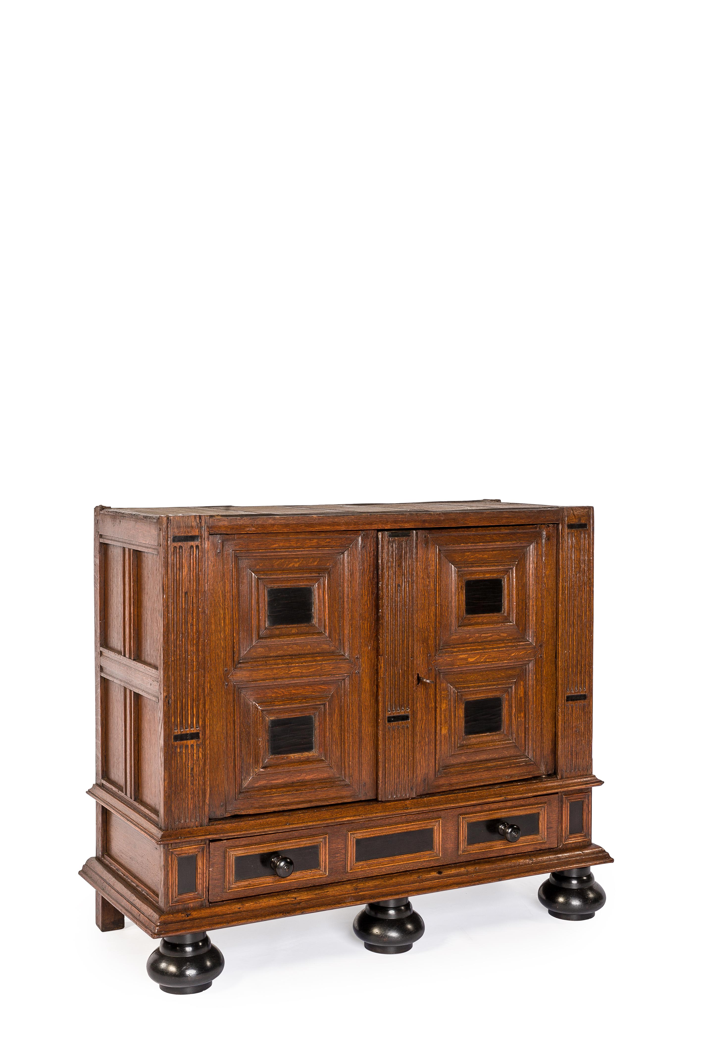 This extraordinary and friendly sized cupboard is made of the finest watered oak in the tradition of the Dutch Renaissance during the “Dutch golden age” It is a two-story four-door cabinet with one drawer over large ebonized bun feet. This cabinet