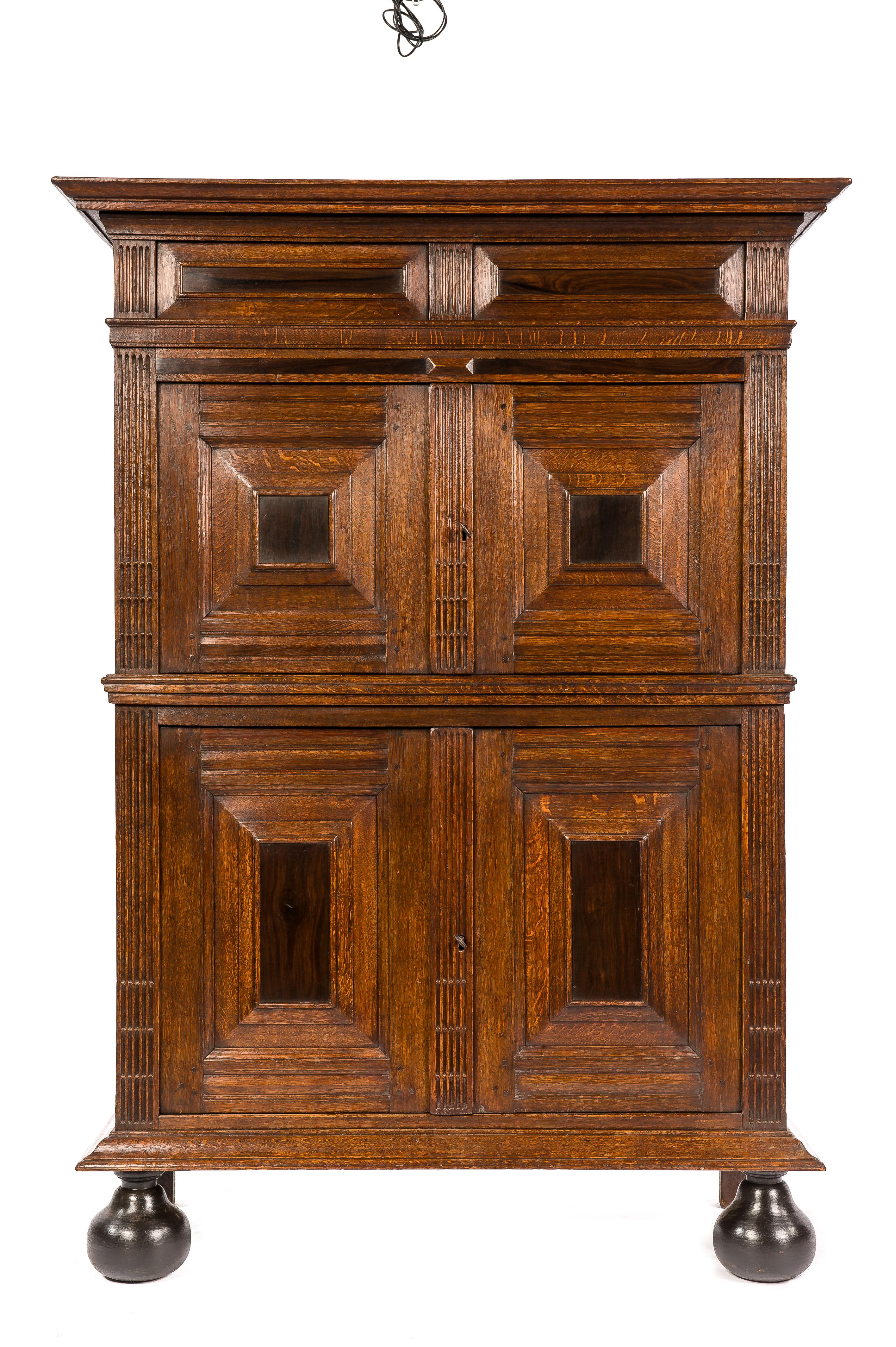 This beautiful and friendly-sized cupboard is made of the finest watered oak in the tradition of the Dutch Renaissance during the “Dutch golden age” It is a two-story four-door cabinet over ebonized bun feet. This cabinet is made in the Provence of