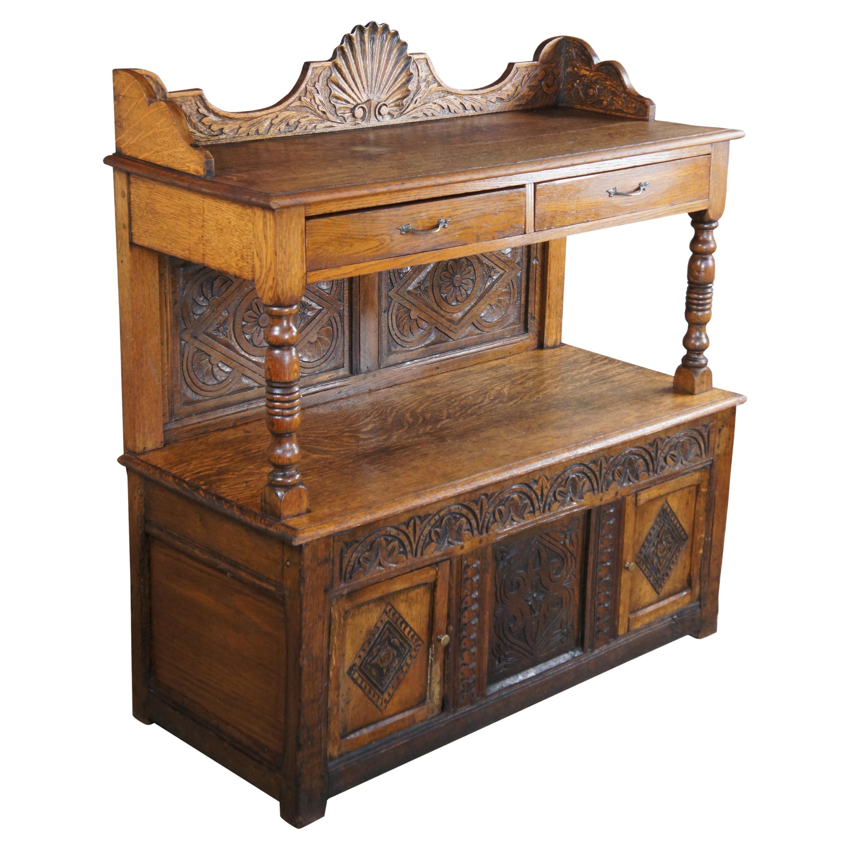 A beautiful English Charles II era sideboard or server, circa 1660s. Reminiscent of the Jacobean era Court Cupboard. Made from quartersawn oak with intricately carved details. Features a rectangular form with a large upper serving area over a frieze
