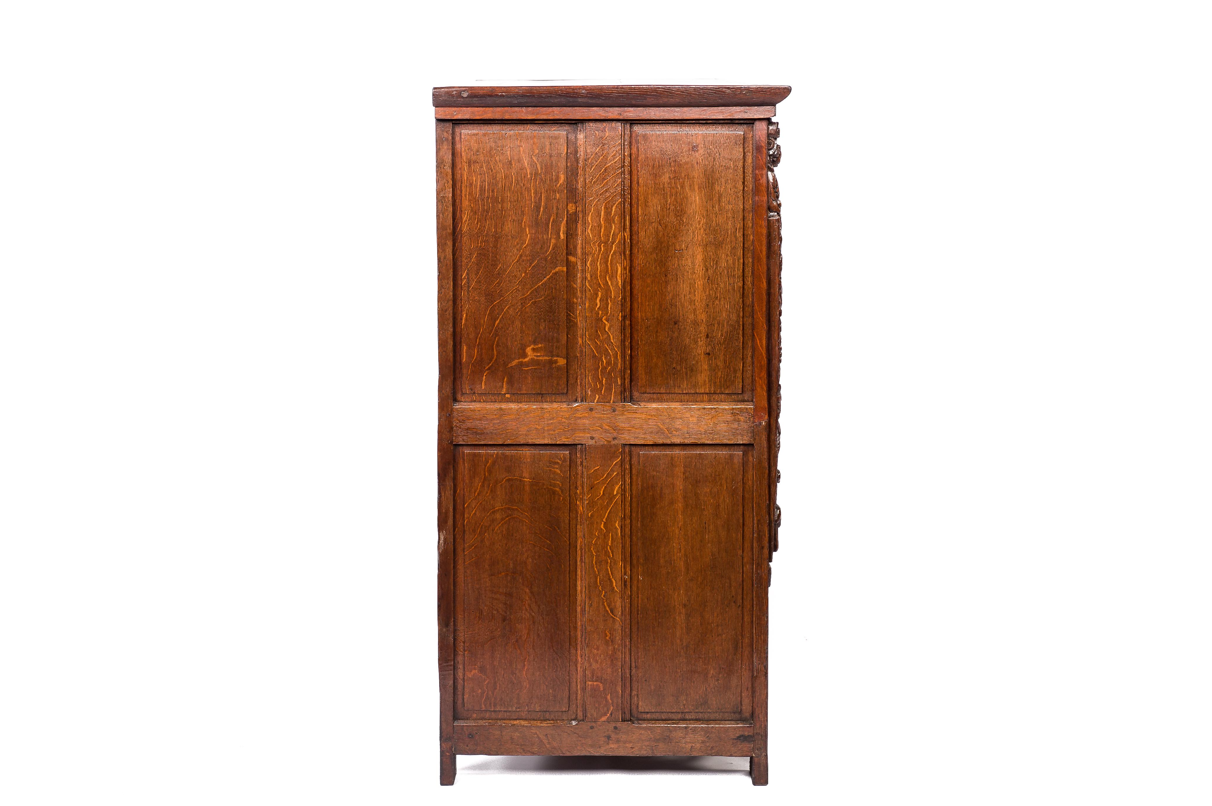 On offer here is an Exquisite 17th Century Oak Two-Door Cabinet from the Carmelite Monastery in Bruges, Belgium. This antique piece, crafted in the Southern Netherlands around 1635, is a true gem. Constructed from the finest quality European summer