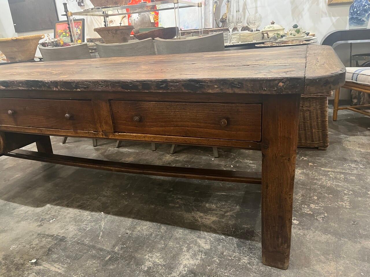 Transport yourself back to the charming ambiance of 17th-century France with this exquisite Rustic Antique French Oak Baker/Work Table. Crafted with timeless elegance and sturdy oak, it bears the marks of age and artisanal craftsmanship, adding