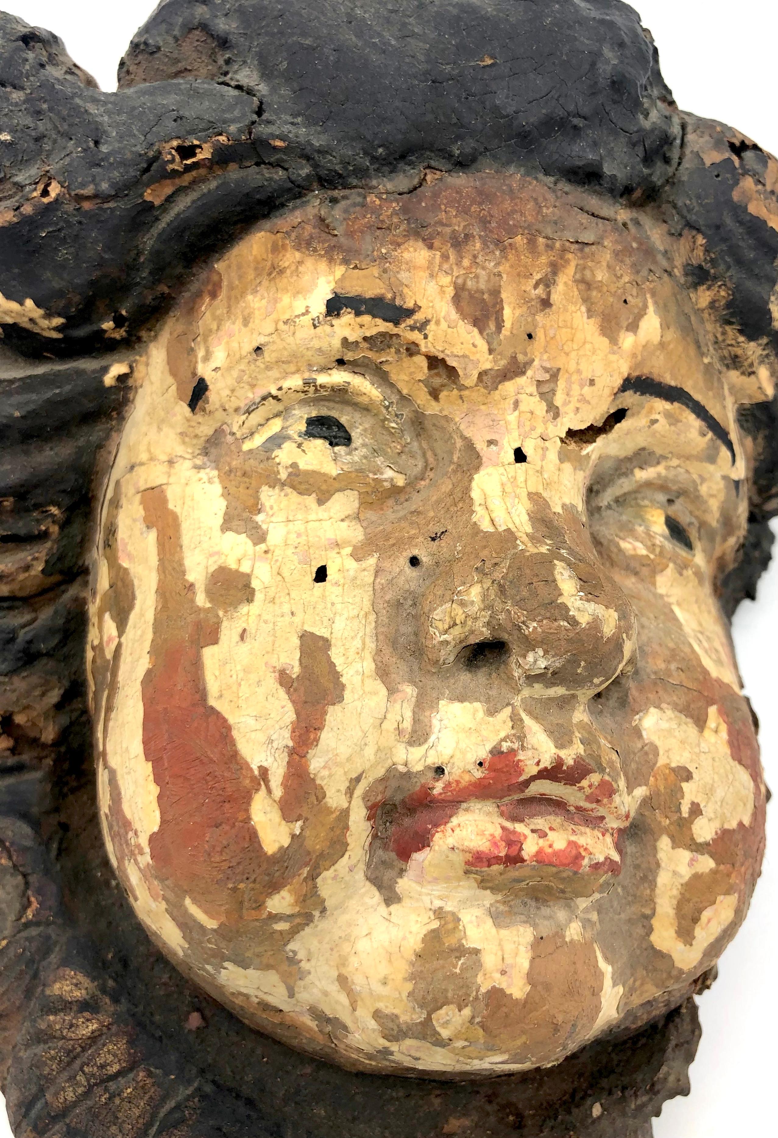 This beautiful 17th century carved angel has retained its original paint.
