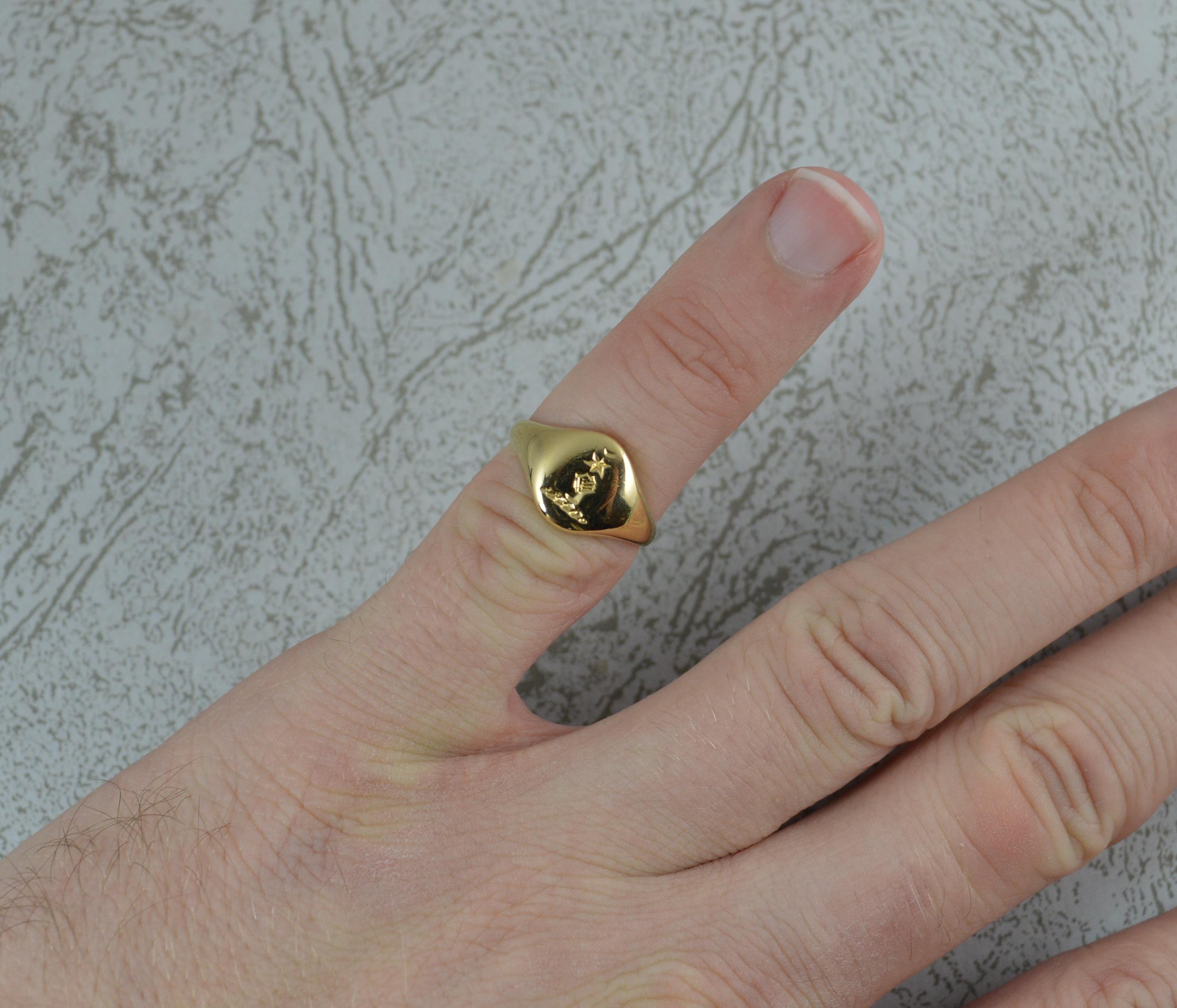 A superb pinky intaglio signet ring.
Solid 18 carat yellow gold example.
Designed with the clenched fist reaching up from the ground with star above
8mm x 9.5mm head approx.

CONDITION ; Very good. Clean solid shank. Crisp intaglio. Polished. Please