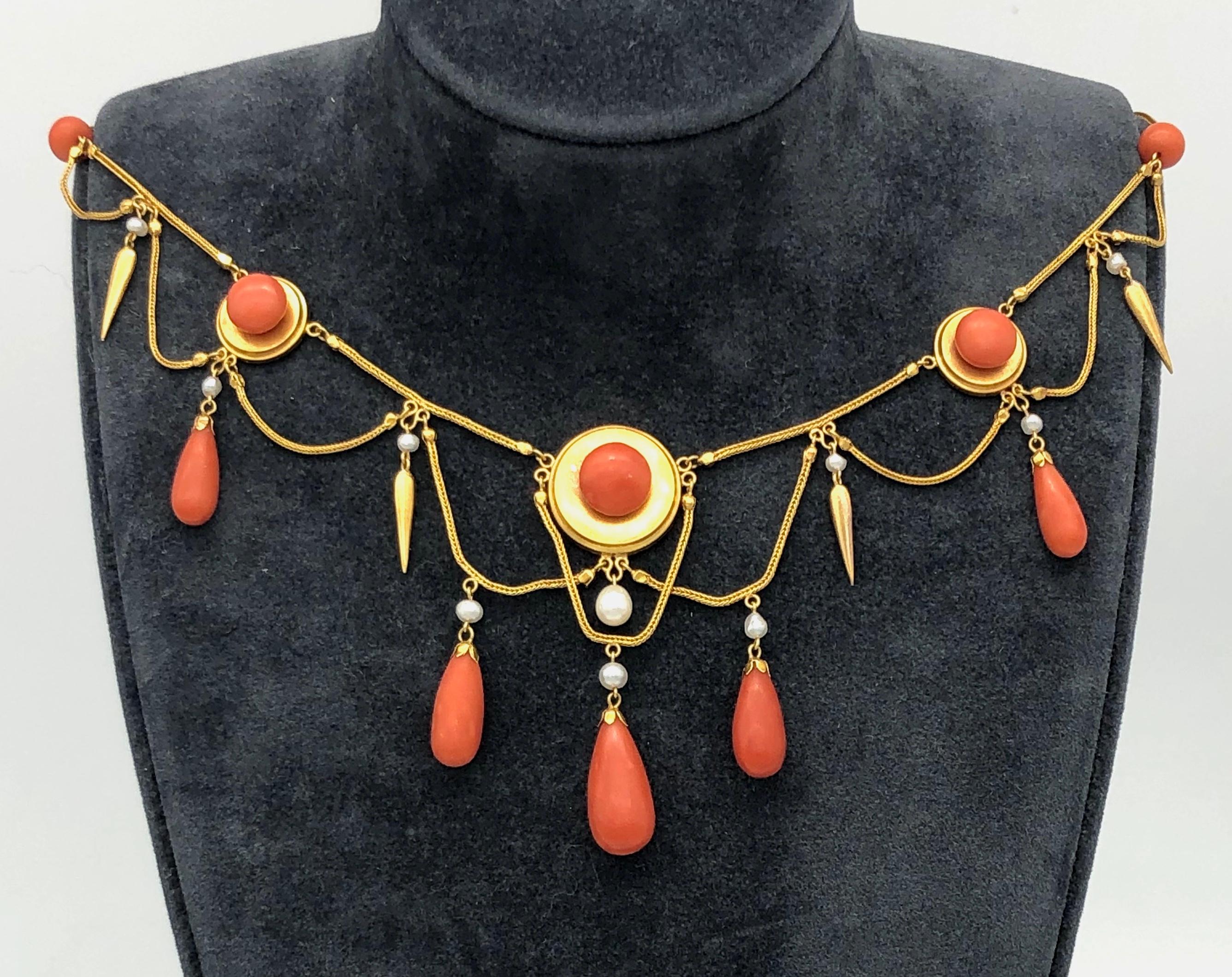 Very elegant and delicate necklace made out of 18 karat gold around 1870 in the neo archeological style. Fine fox tail chains alternate with coral beads and round gold disks reminiscent of targets. The disks, the larger one as centrepiece of the