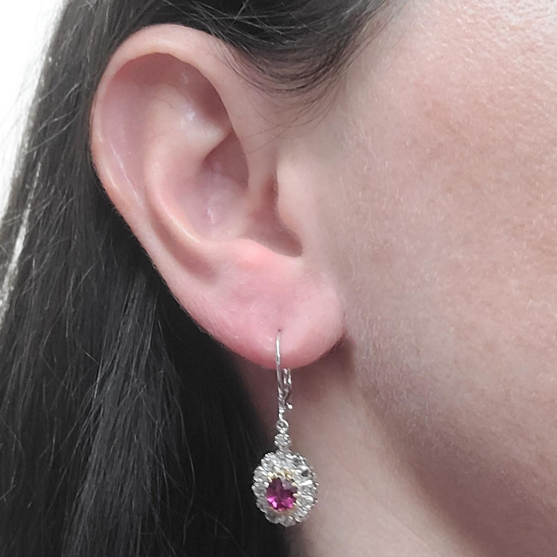 Antique 18 Karat White & Yellow Gold Drop Earrings Featuring 2 Oval Rubies Totaling Approximately 1.00 Carat & 26 Rose Cut Diamonds Totaling Approximately 0.50 Carats. French Wire With Hinged Back. Finished Weight Is 5.0 Grams.