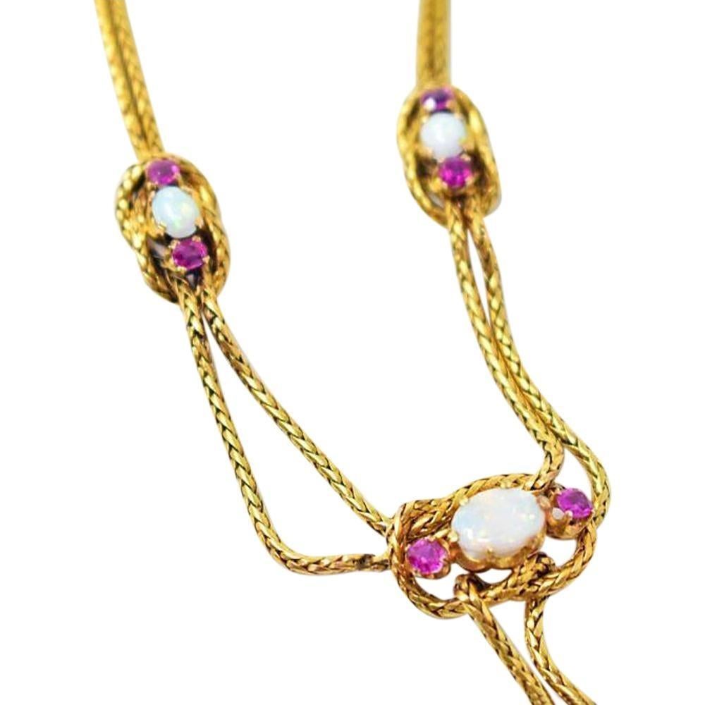 Antique  18K Gold Sapphire Opal Rope Knot Necklace
1.20 Carat Total Weight of Vibrant Pink Sapphires
3 Lively Opals 
Gorgeous Double Chain Rope Knot 
Total Weight: 22.8 Grams
16