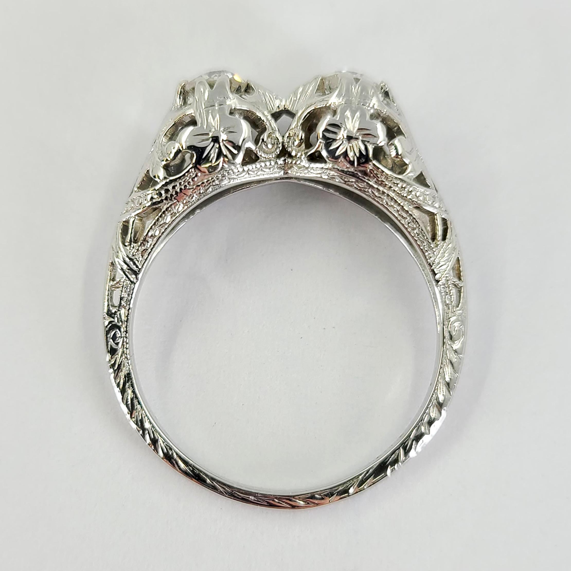18 Karat White Gold Antique Ring Featuring 2 Old Mine Cut Diamonds Totaling Approximately 0.40 Carats Set In A Open Work Floral Mounting With Engraved Detailing. Finished Weight Is 3.0 Grams. Finger Size 6; Purchase Includes Sizing Upon Request.