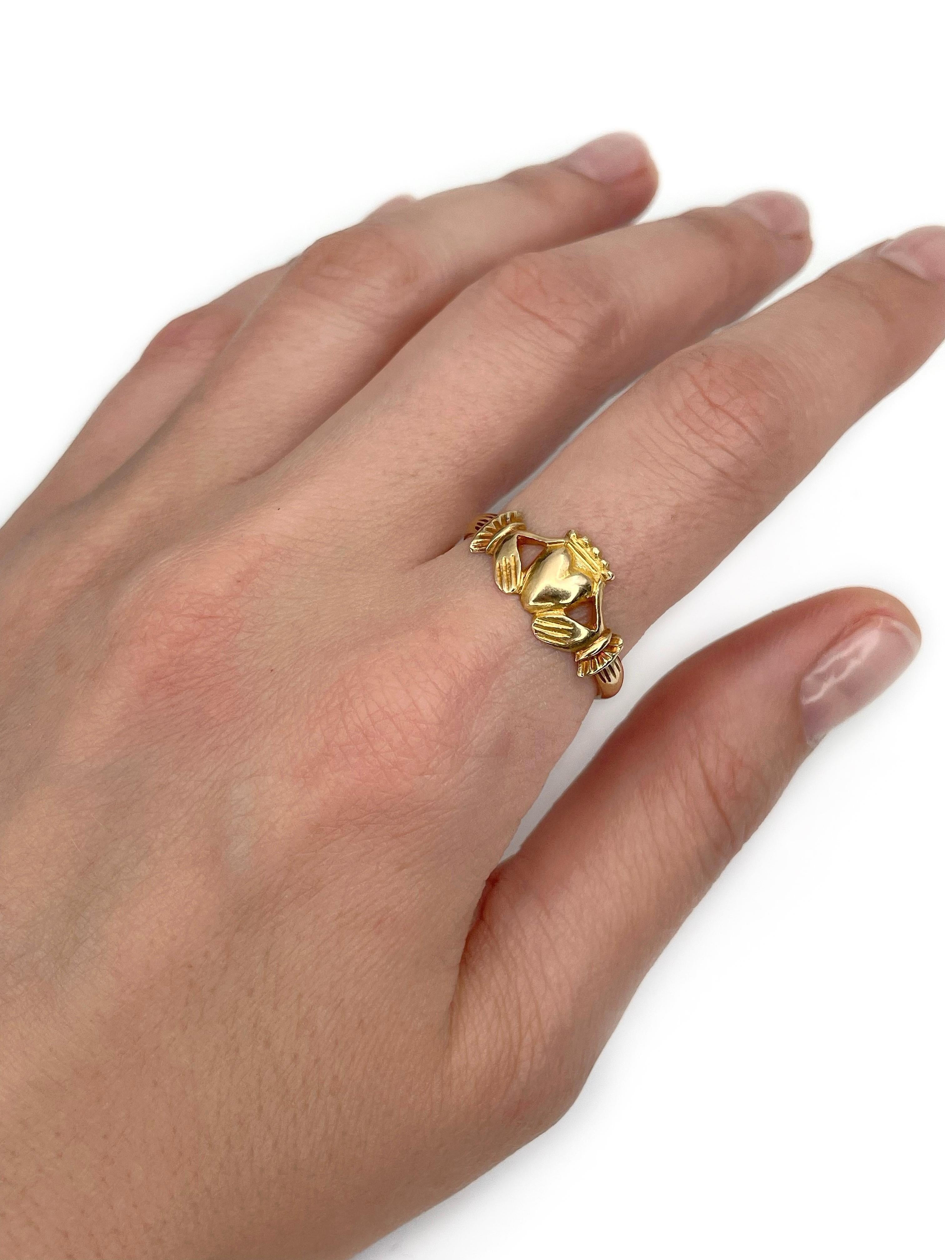 This is an antique Claddagh engagement ring crafted in 18K yellow gold.

Has an owl hallmark stamped on the shank. 

The Claddagh is a traditional Irish jewelry motif that dates back to the 17th century. The heart symbolizes love, the crown -