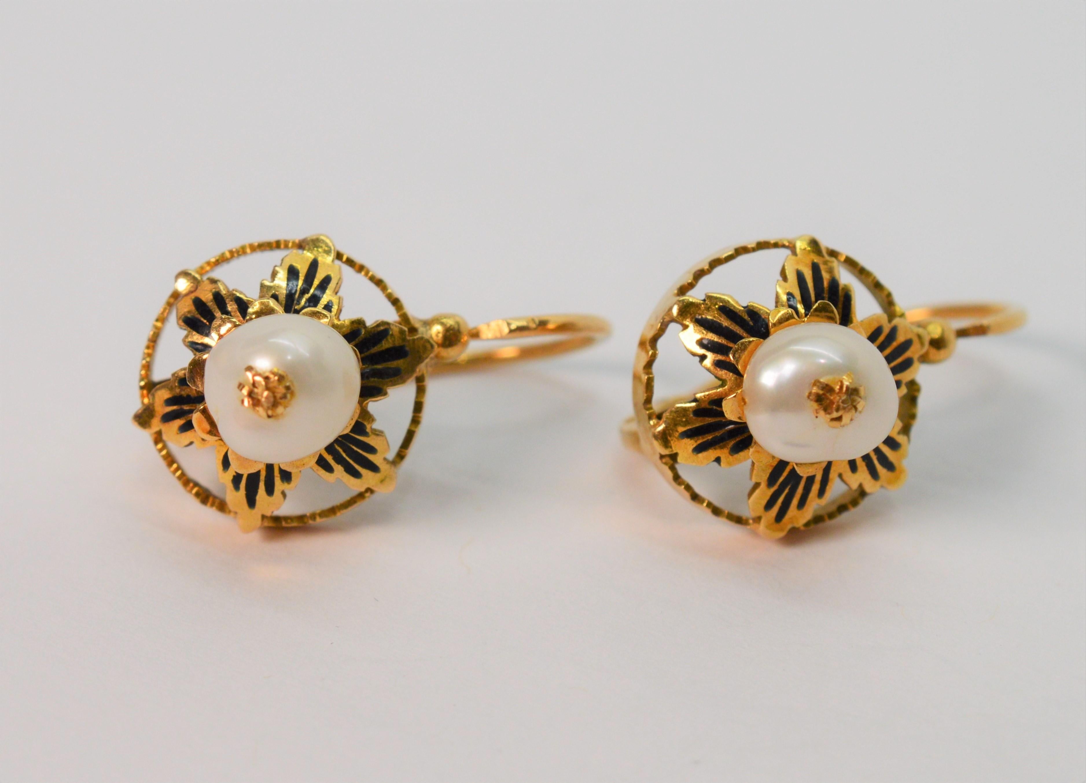 Simple antique elegance, made of 18K yellow gold. Floral inspired with hand painted black enamel accents and natural freshwater pearl centers, this handmade antique pair with lever back closures for pierced ears measures approximately 1/2 inch and