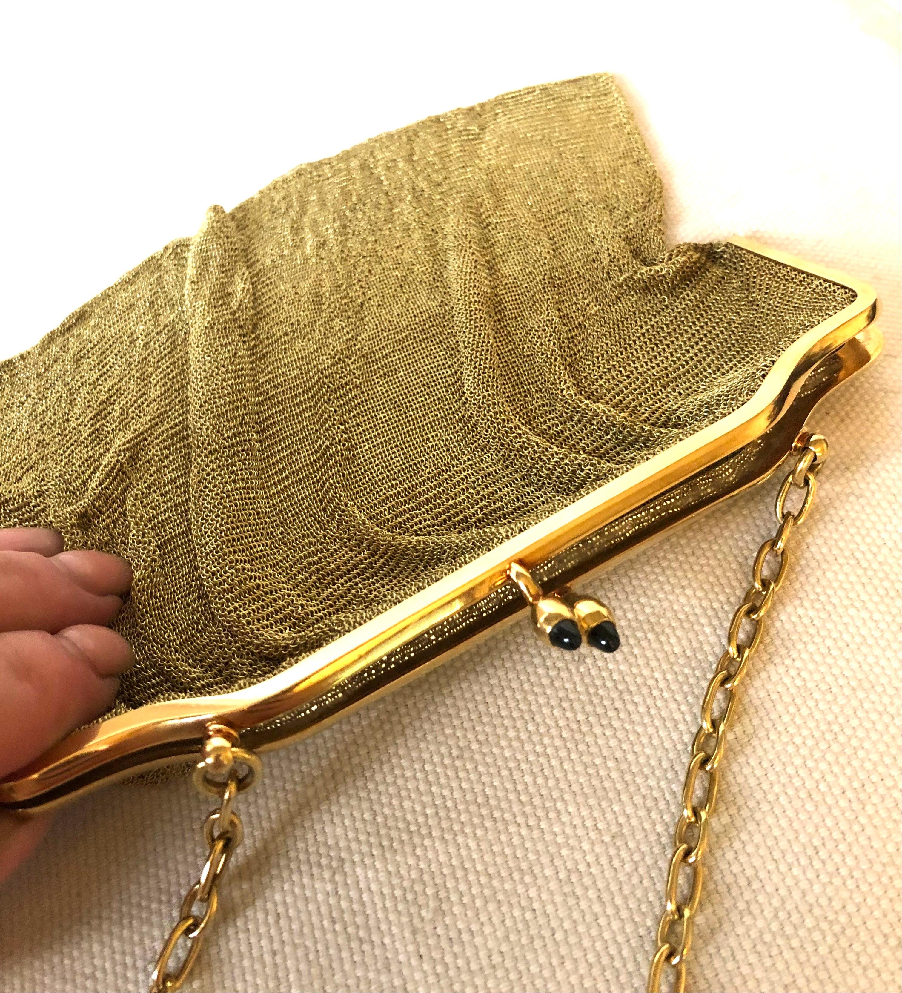An extremely rare antique vintage mesh purse made of 18K yellow gold. A very sophisticated object which will complete any special outfit. The lock on the bag is decorated with two cabochon sapphires. and the handle is represented by golden chain 13