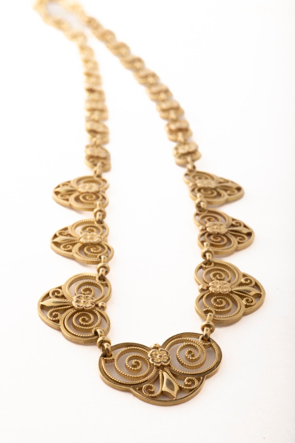 A very French necklace from the Art Nouveau period that is typical of French design of the era. It is graceful and lacy as its links graduate all around the neckline. French Art Nouveau jewelry took gold to new uses by creating flowing curvaceous