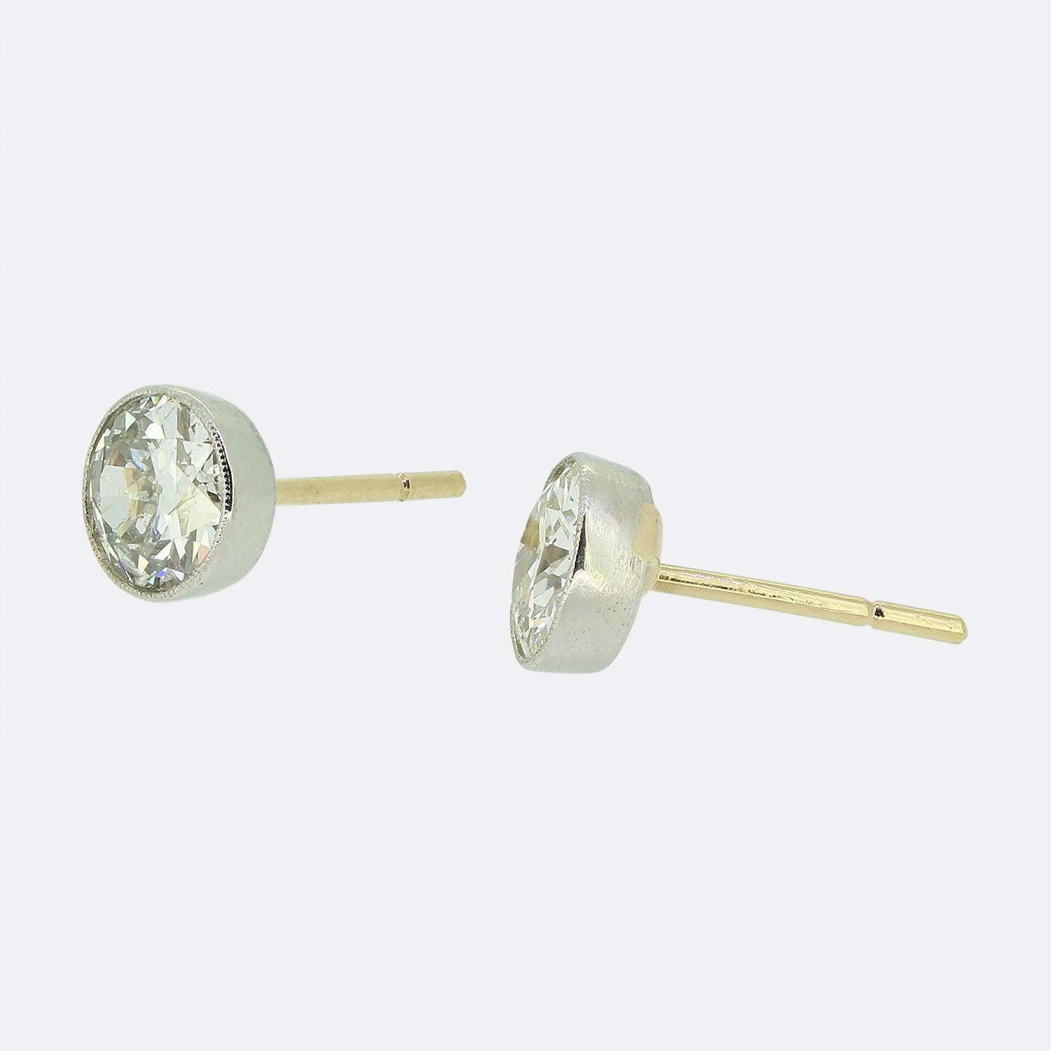 Here we have a classically styled pair of diamond stud earrings. Each antique piece features a single round faceted old European cut diamond which has been finely milgrain set in platinum before being made complete by an 18ct yellow gold post and