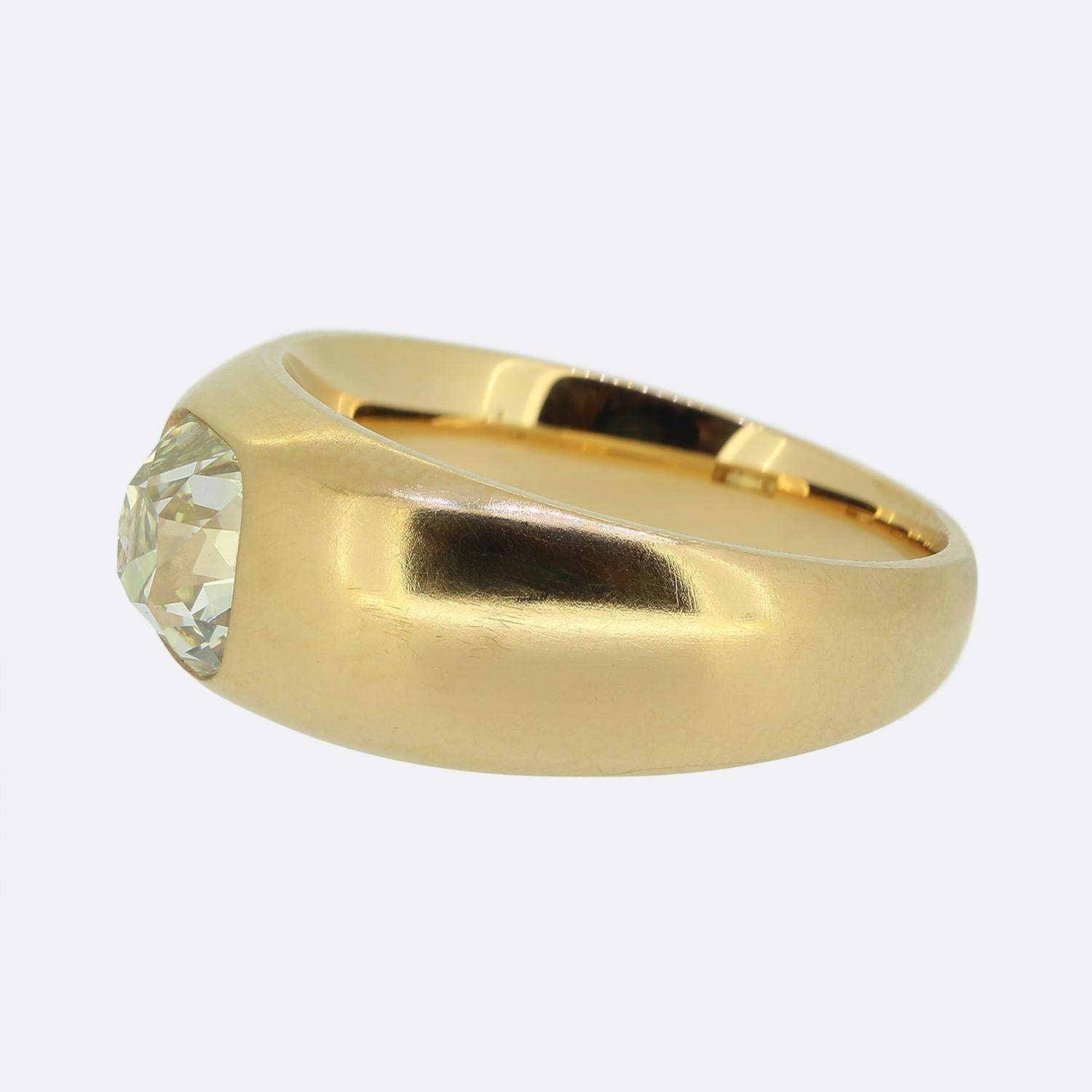Here we have a breathtaking single stone diamond ring. This timeless piece has been crafted from a rich 22ct yellow gold with a slight rose tint and features a 1.80 carat old cushion cut diamond at the centre of the face. This substantial stone sits
