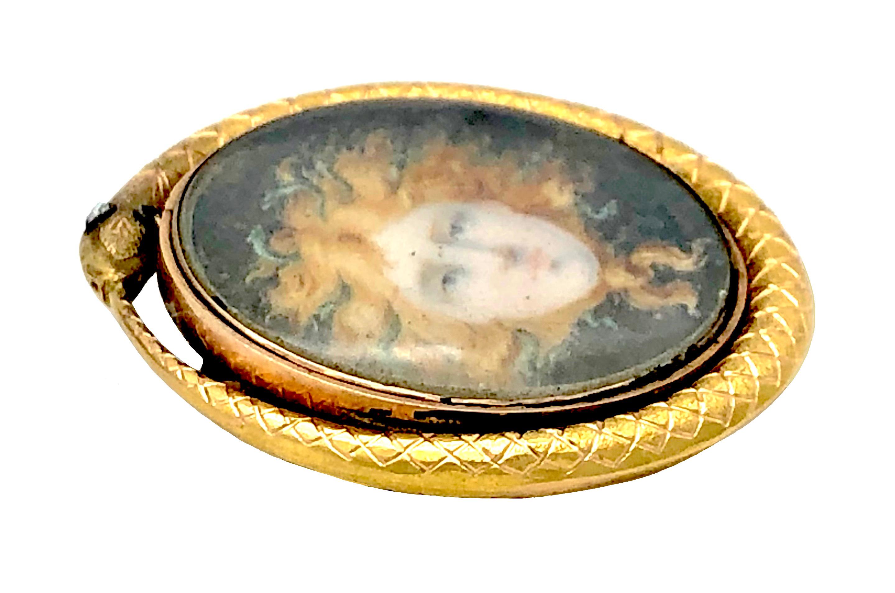 This beautiful gold mounted painting of a medusa's head has been painted on porcelain around 1800. The snake with it's silverset diamond eyes is biting it's own tail, a symbol for eternity.