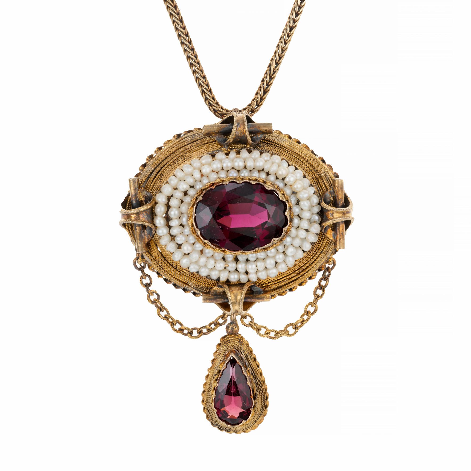 Antique, early 1800's garnet and pearl domed pendant necklace. Oval garnet center stone with a 3 row halo of pearls, set in 14k yellow gold with a pear shaped garnet dangle. 18 inch 14k yellow gold chain. 

One genuine reddish Garnet, approx. total