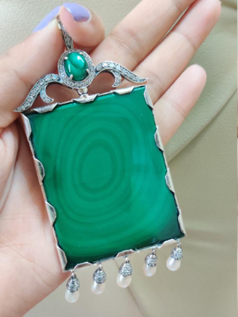 This Antique 180.42 Carat Malachite, Pearl and CZ Sterling Silver Pendant is meticulously crafted from the finest materials and adorned with stunning malachite, pearl and zircon where malachite teaches to take responsibility for one's thought and