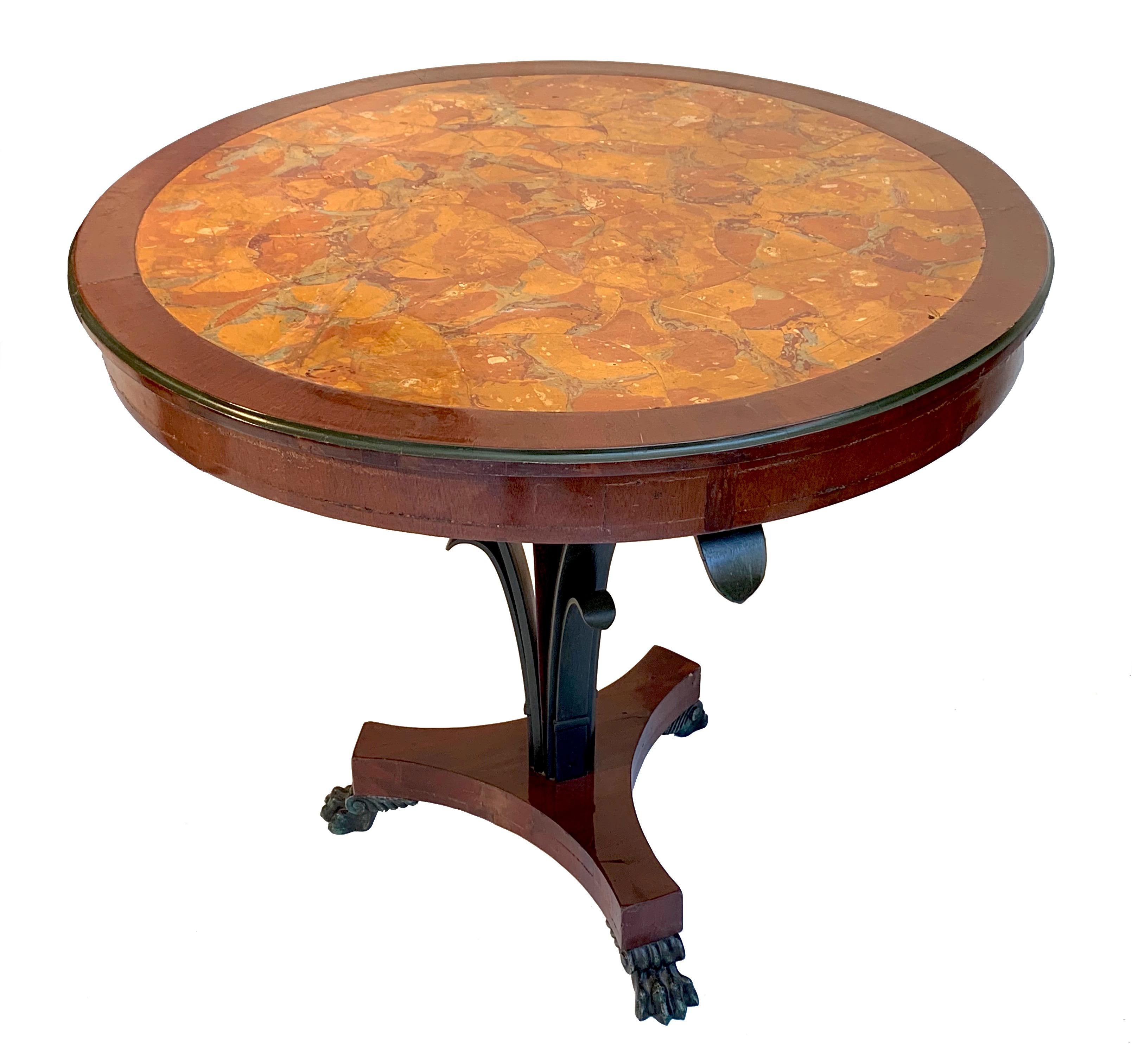 This elegant and beautifully proportioned guéridon table was made in northern Italy, circa 1810. It is made out of mahogany and has a fine Scagliola top. It is supported by a centre column that is surrounded by three stylized leaves.
The tripod