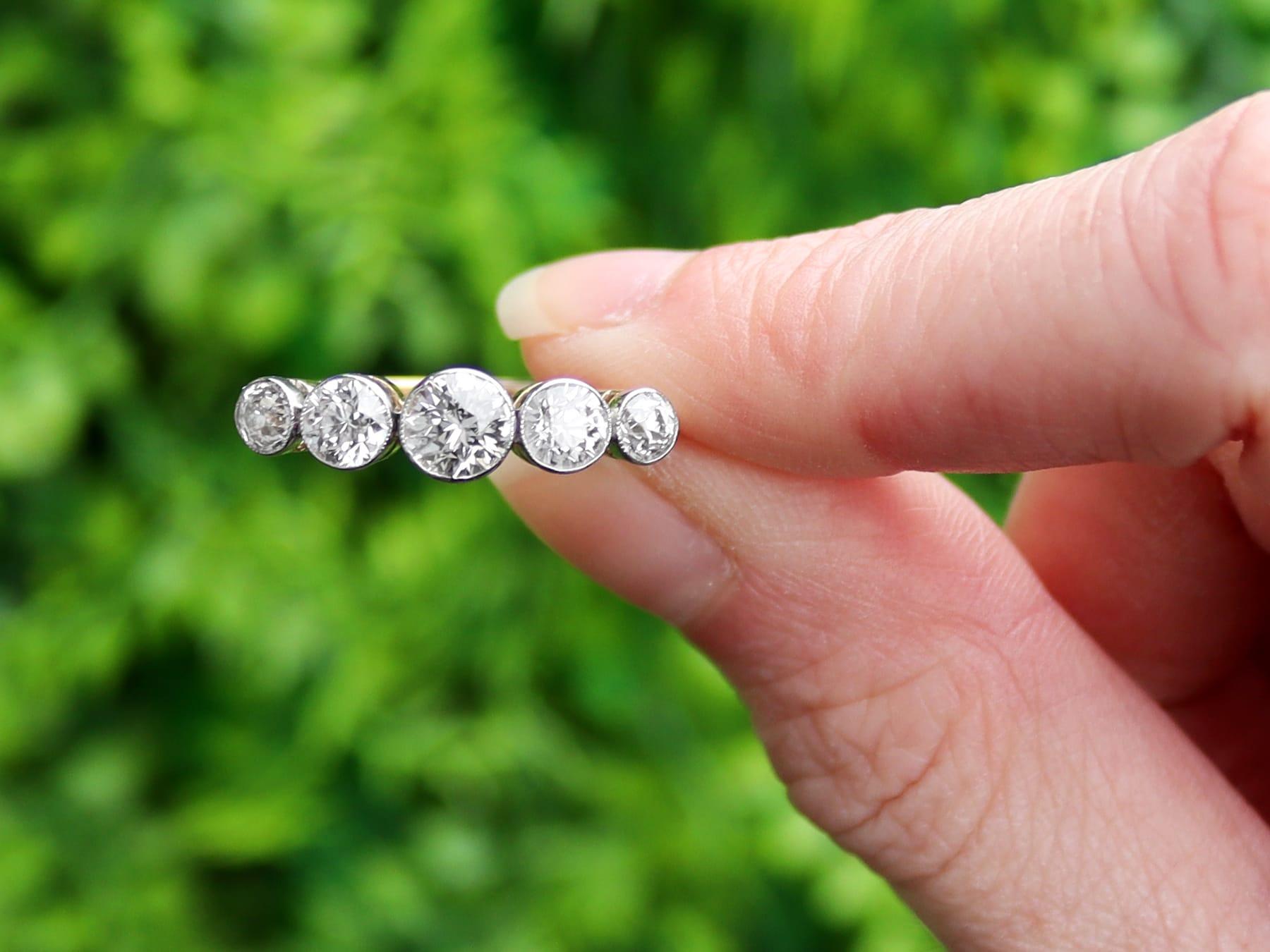 A stunning, fine and impressive antique 1.82 carat diamond and 15 karat yellow gold, platinum set five stone dress ring; part of our diverse antique diamond jewelry collections.

This stunning, fine and impressive five stone diamond ring has been