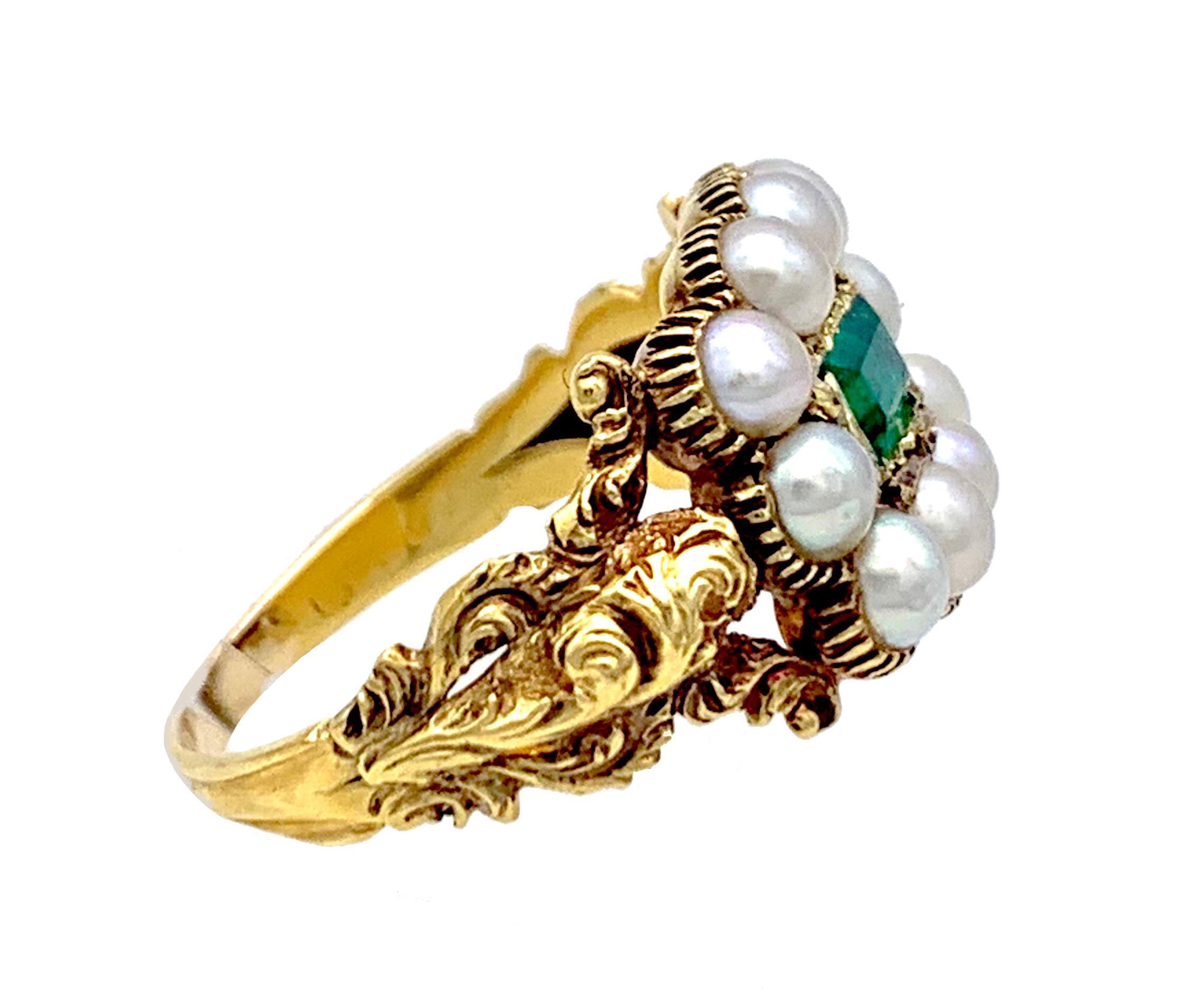 This bright Georgian was ceated in the 1820's. The ring is set with ten natural white oriental half pearls. The pearls are set in a grooved setting that follows the outline of the pearls. The center of the ring head is decorated with a rectangular