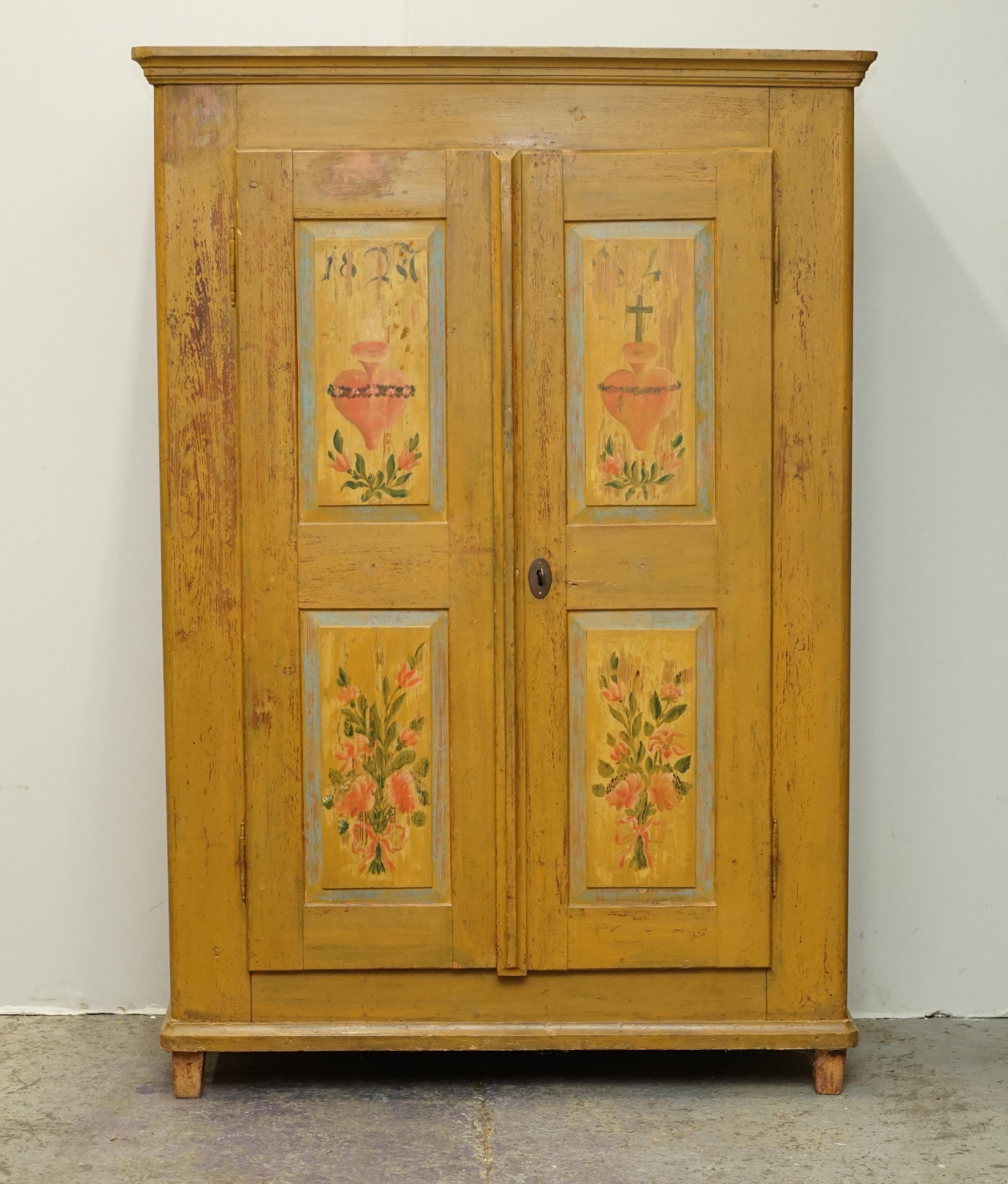 We are delighted to offer for sale this stunning original 1827 dated Antique German Marriage wardrobe in very a rare yellow paint that has the Holy Heart detailing with a cross above

I have recently purchased a very large collection of these