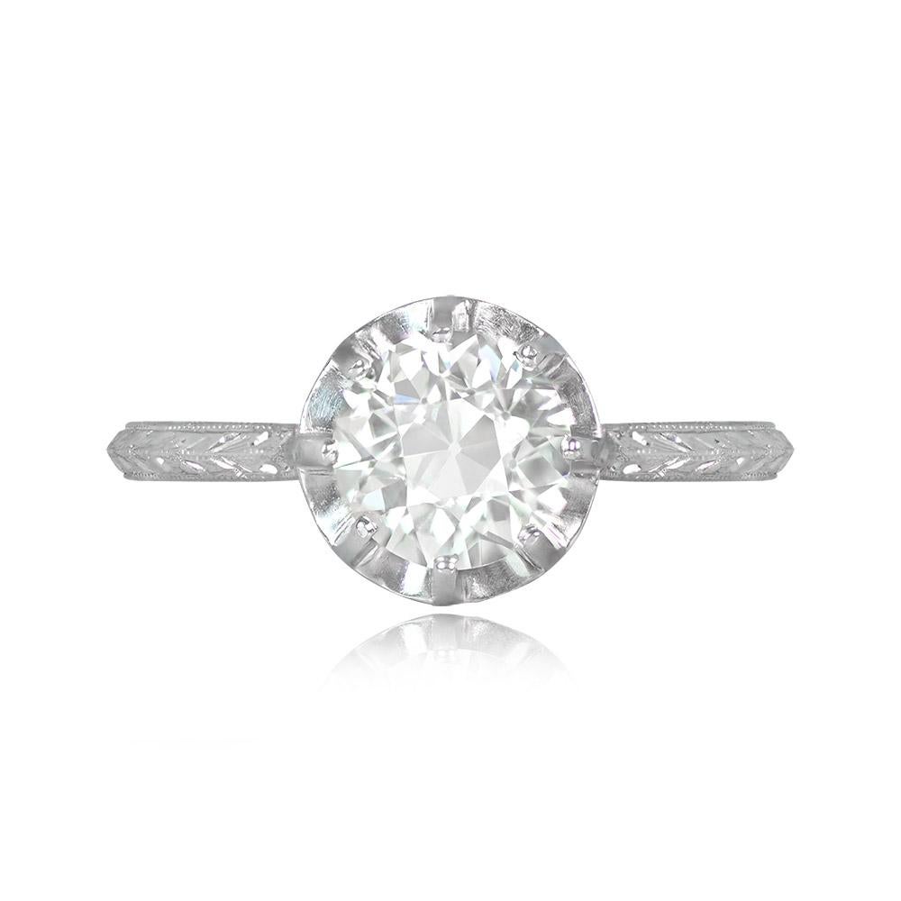 This is an original Art Deco engagement ring with a 1.82-carat old European cut diamond in K color and VS1 clarity, set in prongs. The ring boasts intricate hand engravings and fine milgrain along the shoulders and under-gallery. Crafted in platinum