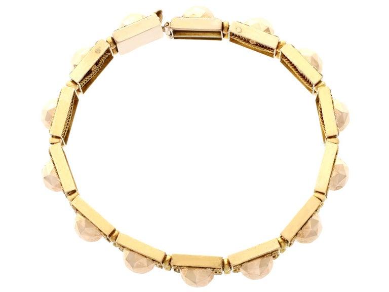 An impressive antique 1830s 18 karat yellow and rose gold articulated bracelet; part of our diverse antique jewelry and estate jewelry collections.

This fine and impressive antique gold bracelet has been crafted in 18 karat yellow and rose