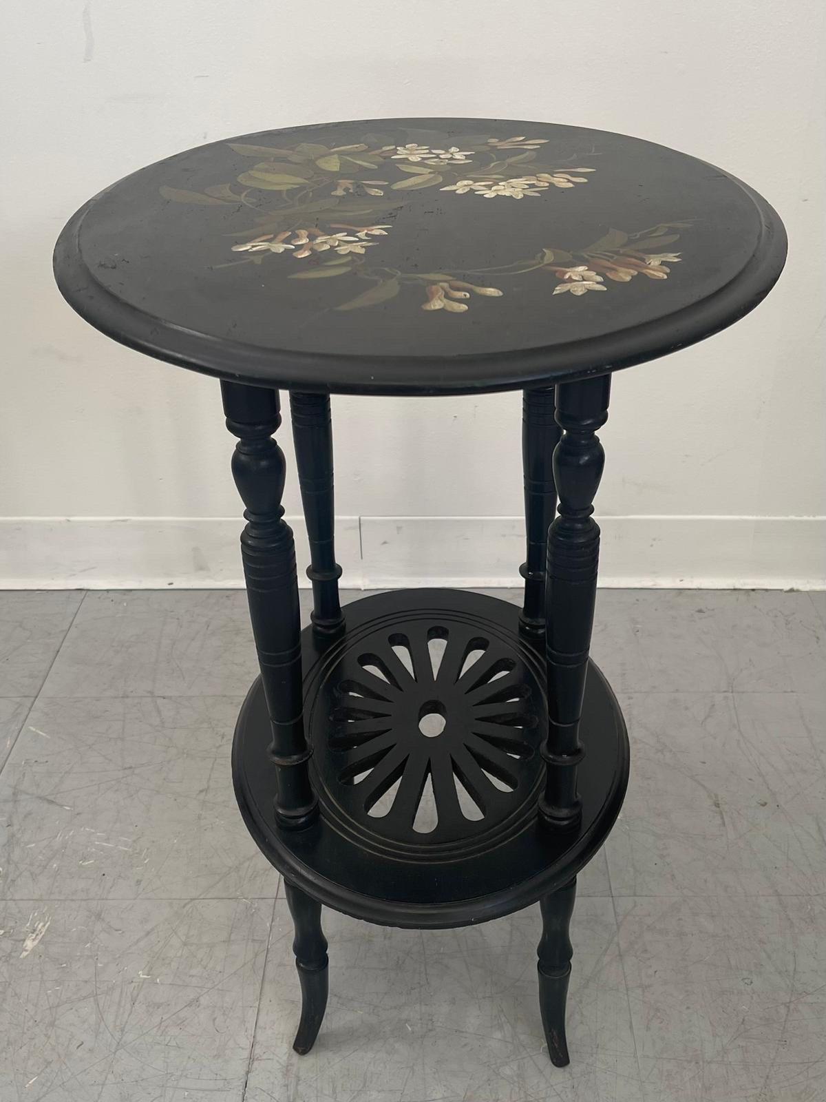 Imported Decorative Table with Floral Motif on the Top. The Second Shelf of the Table has a Floral Cut Out Pattern. The Legs have Unique Carving. No Makers Mark. Vintage Condition Consistent with Age as Pictured.

Dimensions. 21 1/2 W ; 17 D ; 25 H
