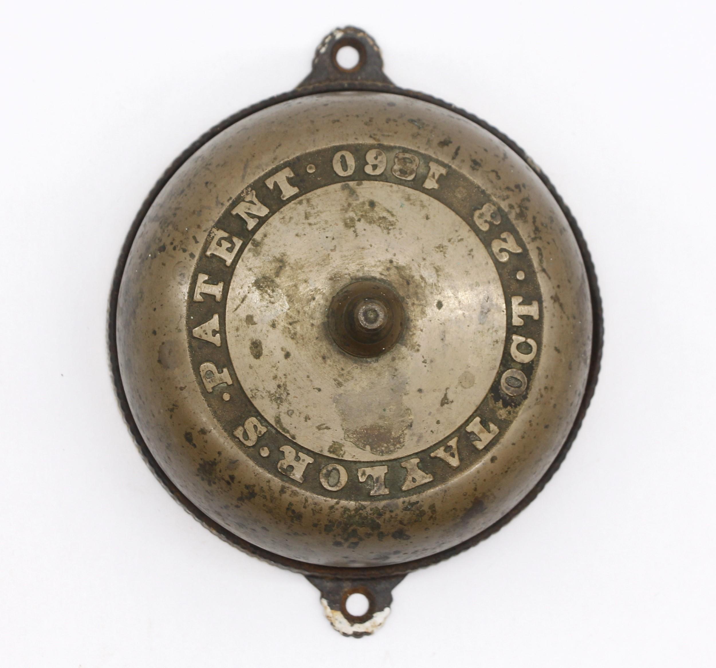 Original 1860s antique mechanical doorbell made by Taylor and is in working condition. Taylor is one of the earliest known manufactures of mechanical bells. Brass cover with a cast iron. It operates by turning the round finger knob that inserts in