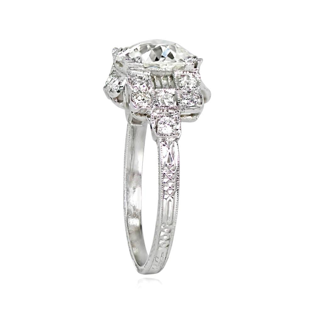 Antique engagement ring with a 1.87 carat old European cut diamond, K color, and VS2 clarity. The platinum ring also features diamonds set in bezels on the shoulders and under the gallery, with hand engravings on the shank. Handcrafted during the