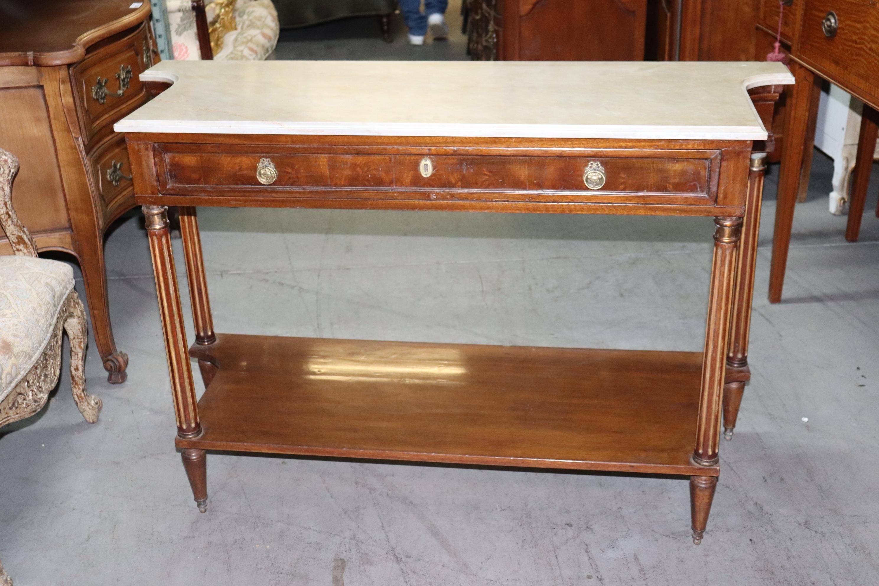 This is a superb antique 1870s era Directoire brass inlaid and marble top console with a beautiful slab of marble and in very good condition for its age. The console measures 52 wide x 34 tall x 19 inches deep and has no condition issues that need