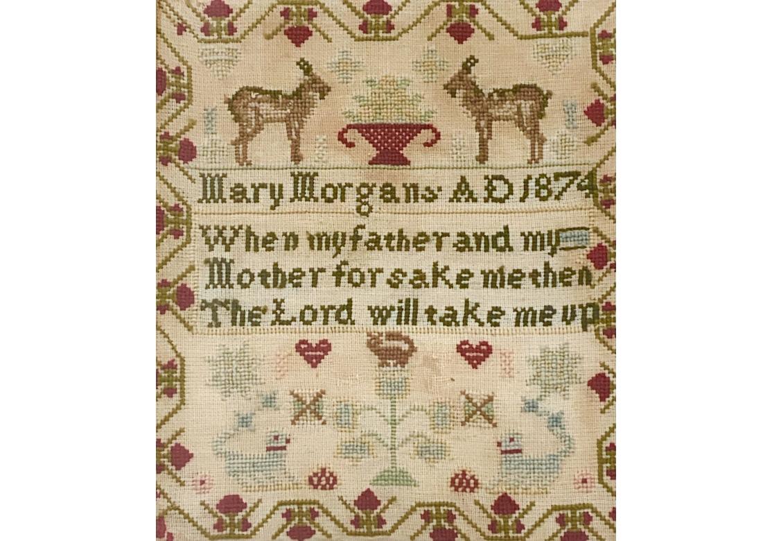 Un antique sampler à l'aiguille de Mary Morgan daté de 1874 avec des mots :

