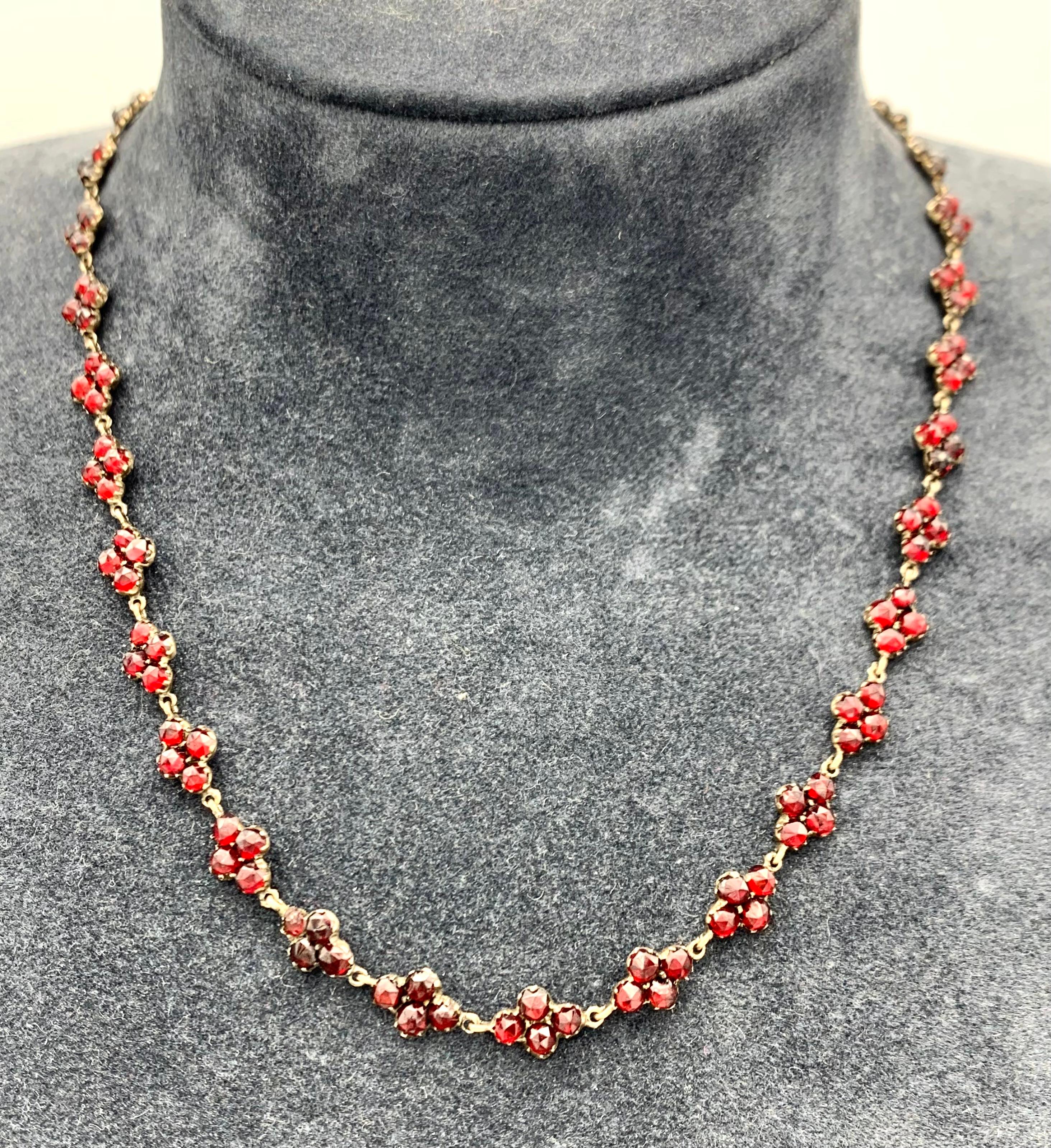 This delicate necklace is set with Bohemian garnets mounted in silver gilt.
The necklace has been much loved and shows an old repair.
 