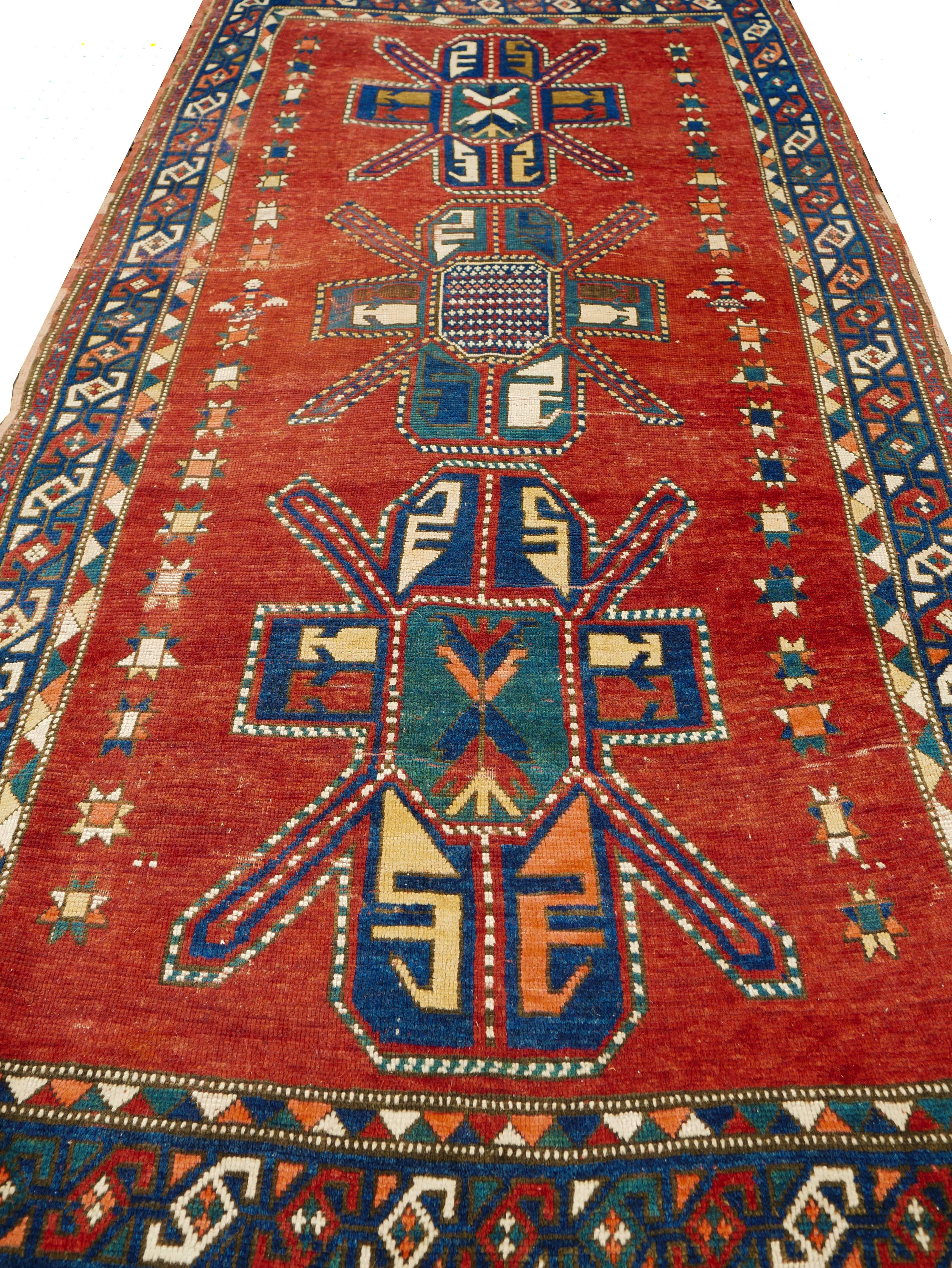 This is a spectacular collector's antique Caucasian Kazak rug dating to the second half of the 19th century (1860-1890) it features three different Seichour cruciform motifs referred to by western scholars as St. Andrew's cross. This carpet is in a