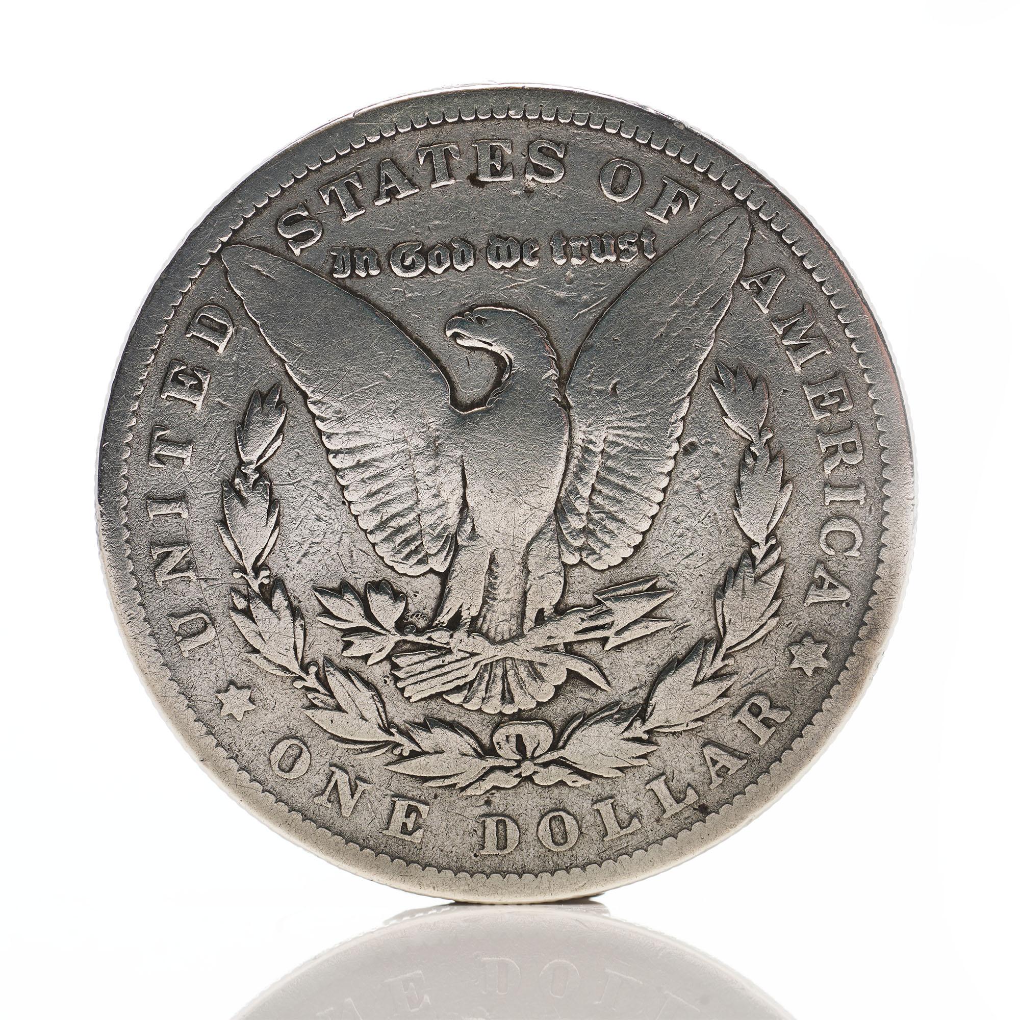Antique 1878 Morgan dollar
Silver fineness: 900 
Made in USA, 1878

1878 is the first year of the popular Morgan dollar series. 

The Morgan Dollar is one of the most famous coins in American history. It evokes images of the Wild West. Cowboys