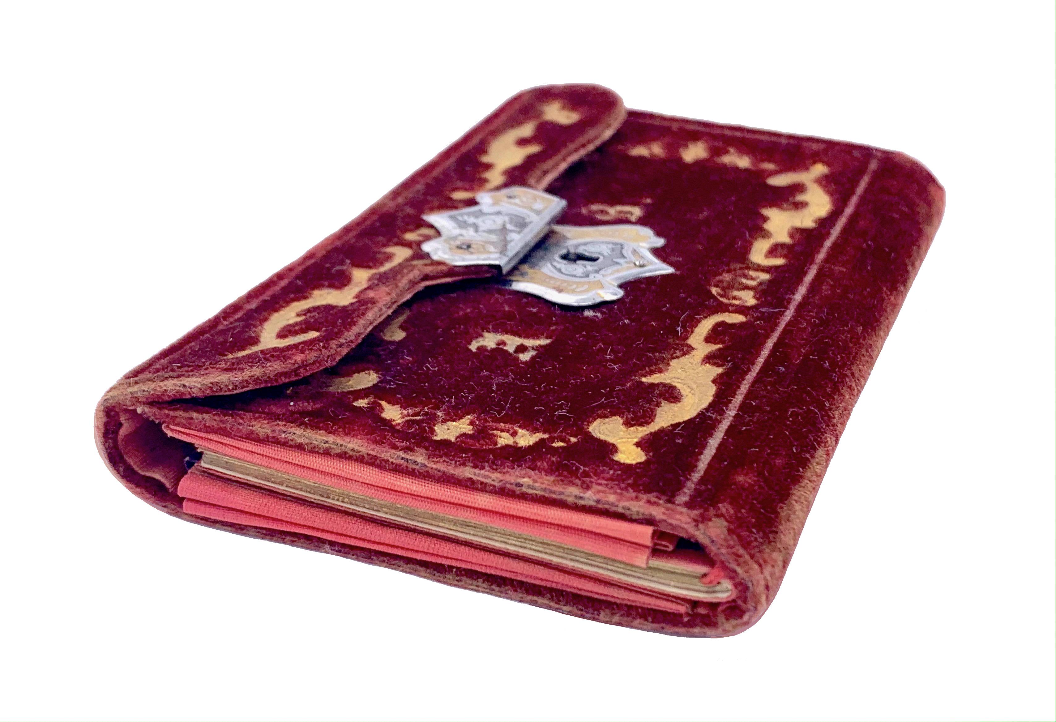 This magnificent small velvet Notebook/ purse has been used as a carnet de bal, a dance card holder. It is decorated with elegant gold embossed Initials and scroll ornaments.
The vine red velvet is in fine condition and is fitted with a wonderful,