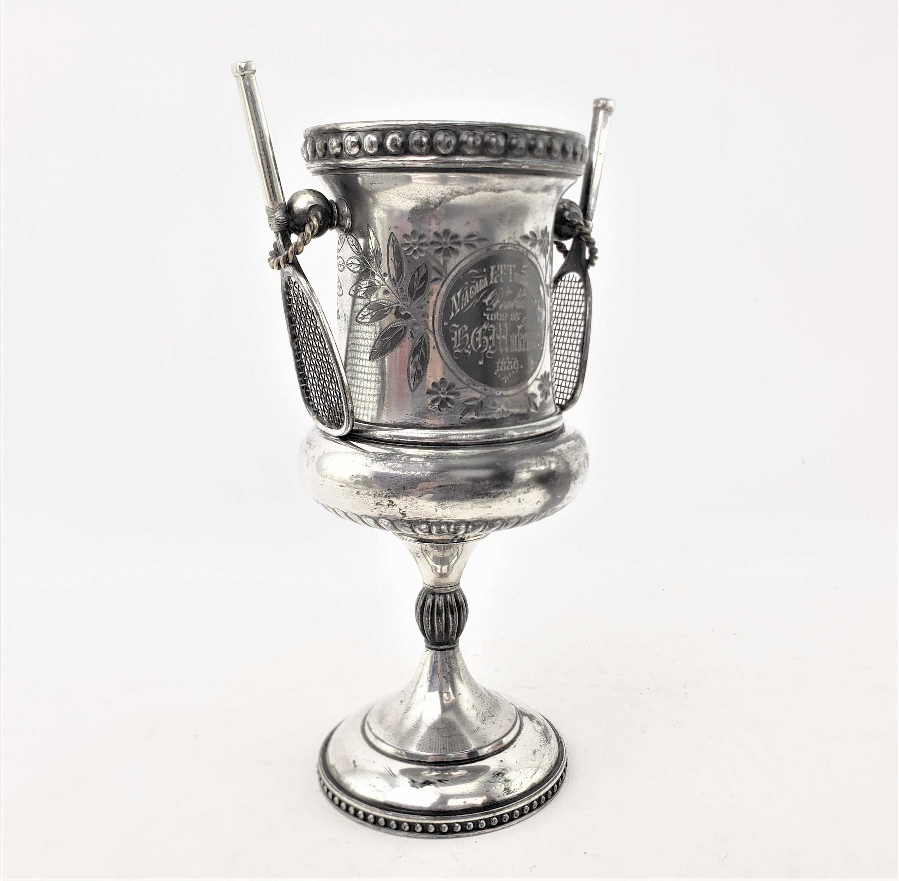 This antique silver plated trophy was made by the well known Simpson, Hall & Miller of England in approximately 1868 in the period Victorian style. The trophy was presented to one of the winners of the ladies doubles tennis tournament in Niagara