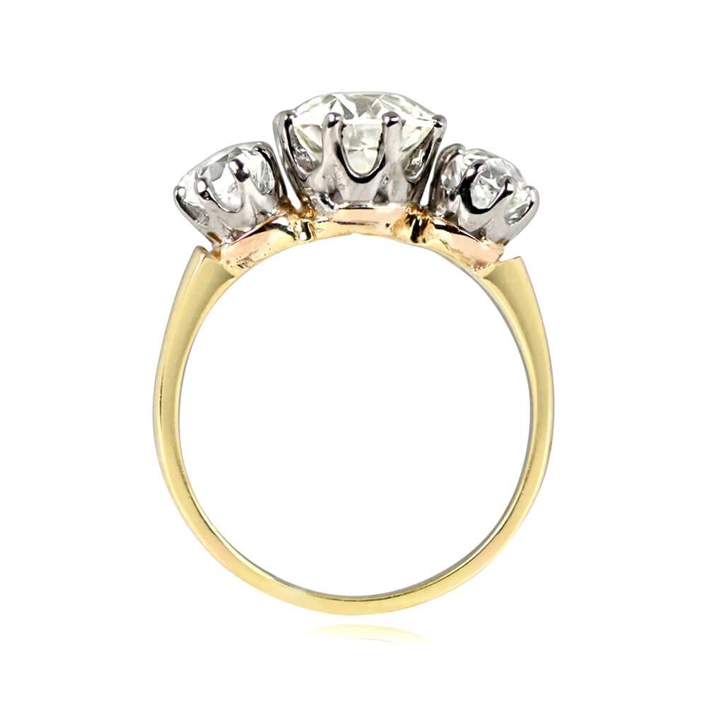 Antique Edwardian three-stone ring features a 1.88 carat old European cut diamond (J color, VS1 clarity) in prong setting, flanked by two old European cut diamonds weighing about 0.50 carats each (I-J color, VS2-SI1 clarity). Handcrafted in platinum