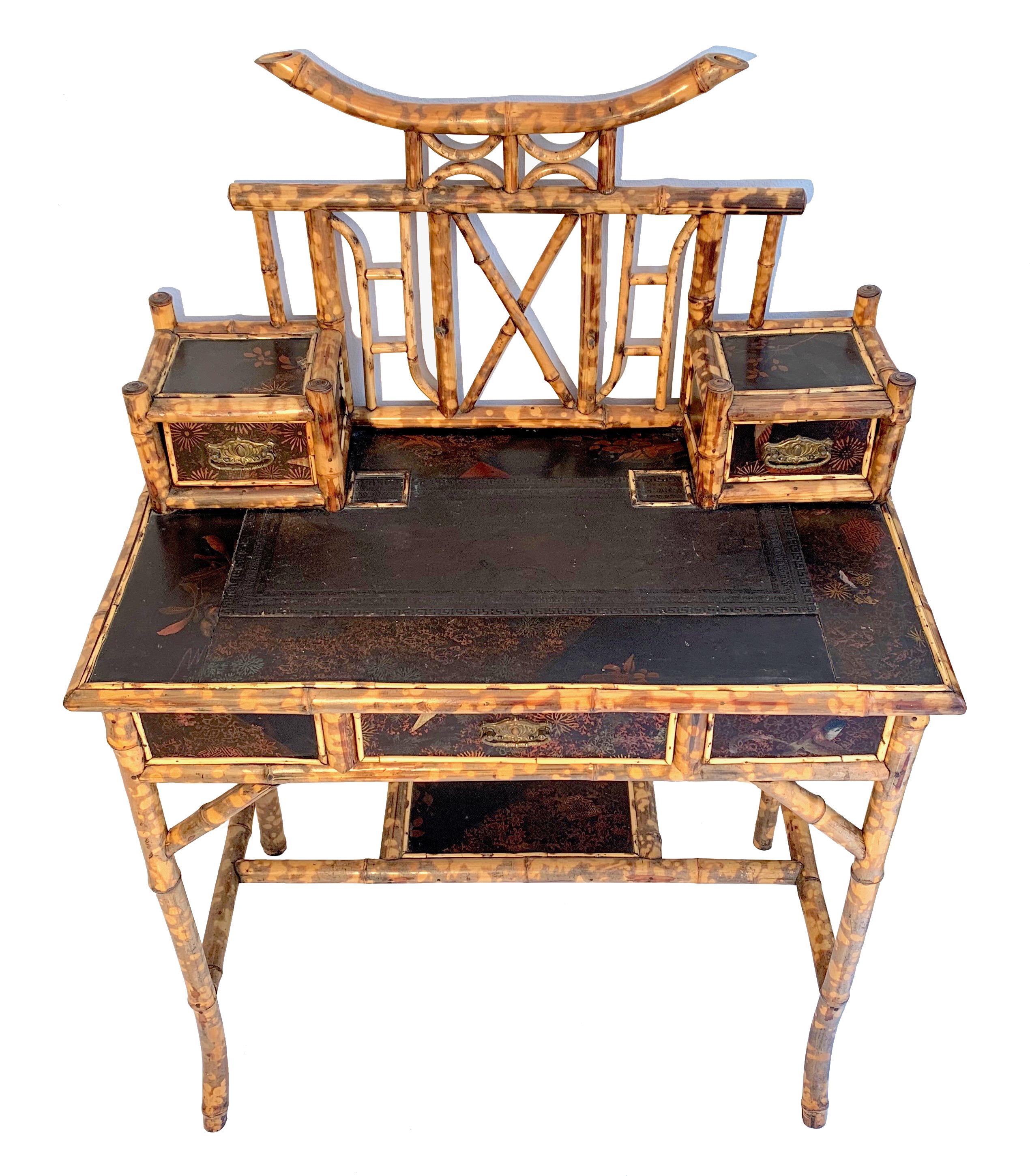 This charming and rare bamboo and wood writing table was crafted in England in circa 1890.
It is decorated with painted lacquer panels in the Japanese taste. The writing surface is covered with embossed leather.