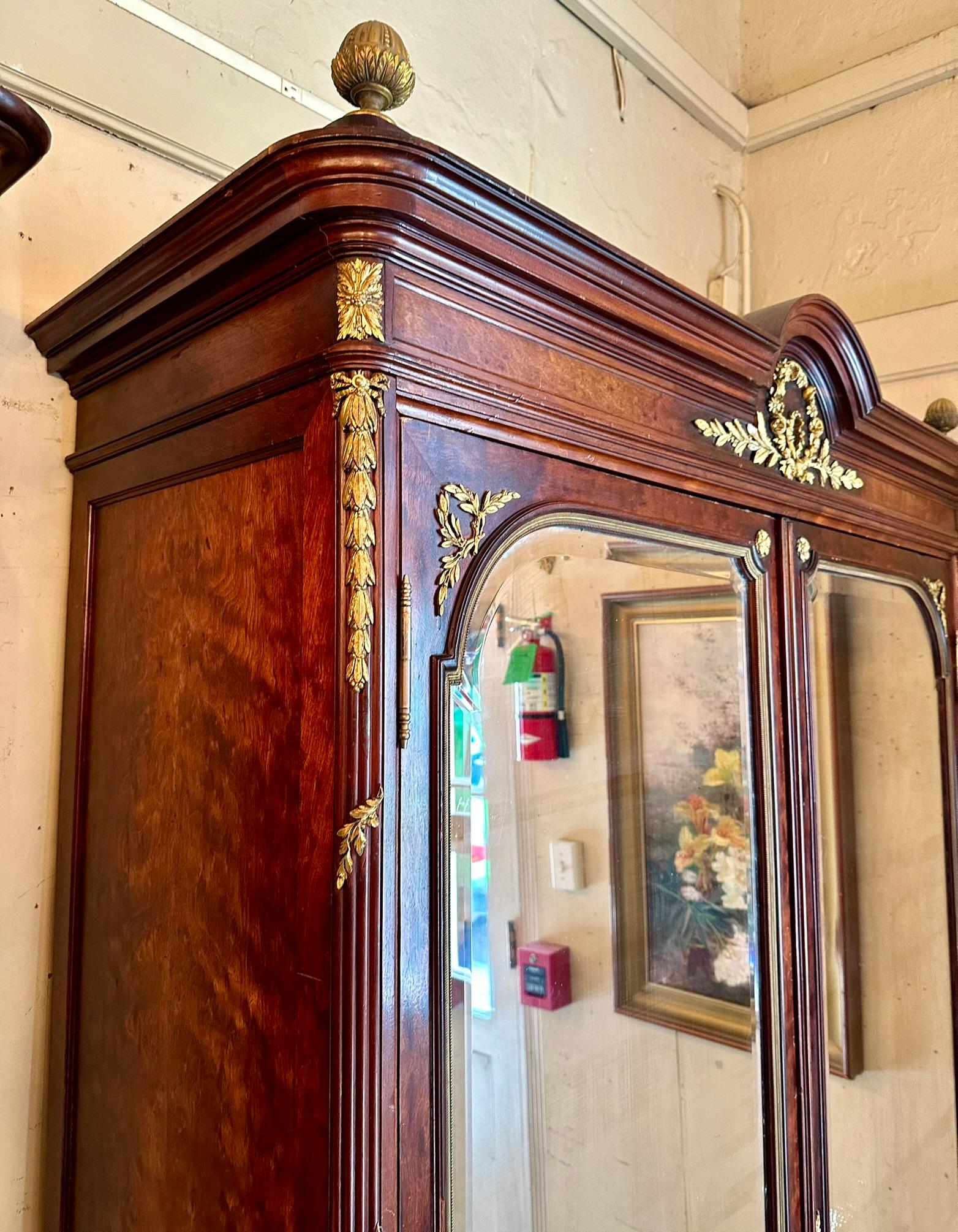 Antique French Gold Bronze Mounted Plum Pudding Mahogany 2 Door Armoire, Circa 1890-1910.  Doors are mirrored with lovely curve-line beveling.