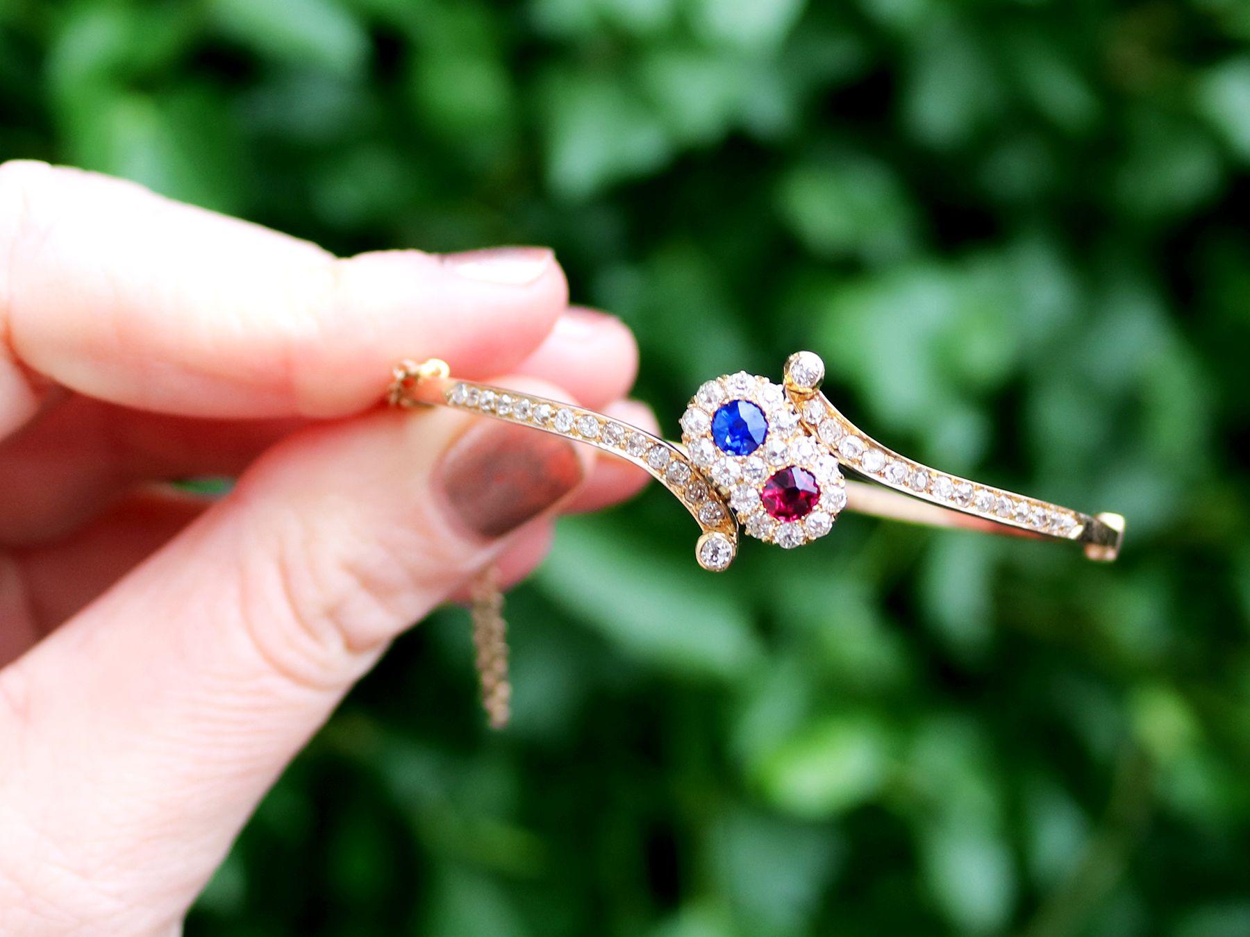 A stunning, fine and impressive antique Victorian 0.45 Ct (total) ruby and blue sapphire, 1.50 Ct diamond and 14k yellow gold twist design bangle.

This stunning, fine and impressive diamond, ruby and sapphire bangle has been crafted in 14k yellow