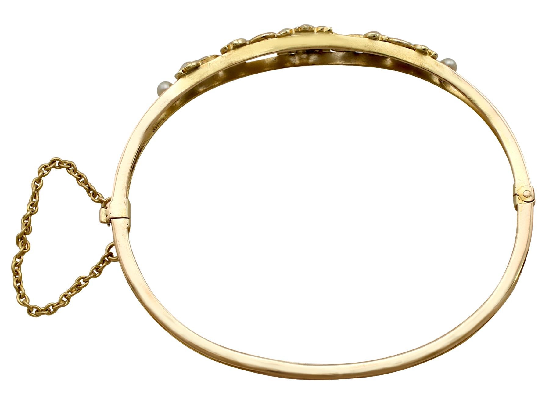 A fine and impressive antique Victorian seed pearl and 15 karat yellow gold bangle; part of our antique jewelry and estate jewelry collections.

This fine and impressive seed pearl bangle has been crafted in 15k yellow gold.

The anterior portion of