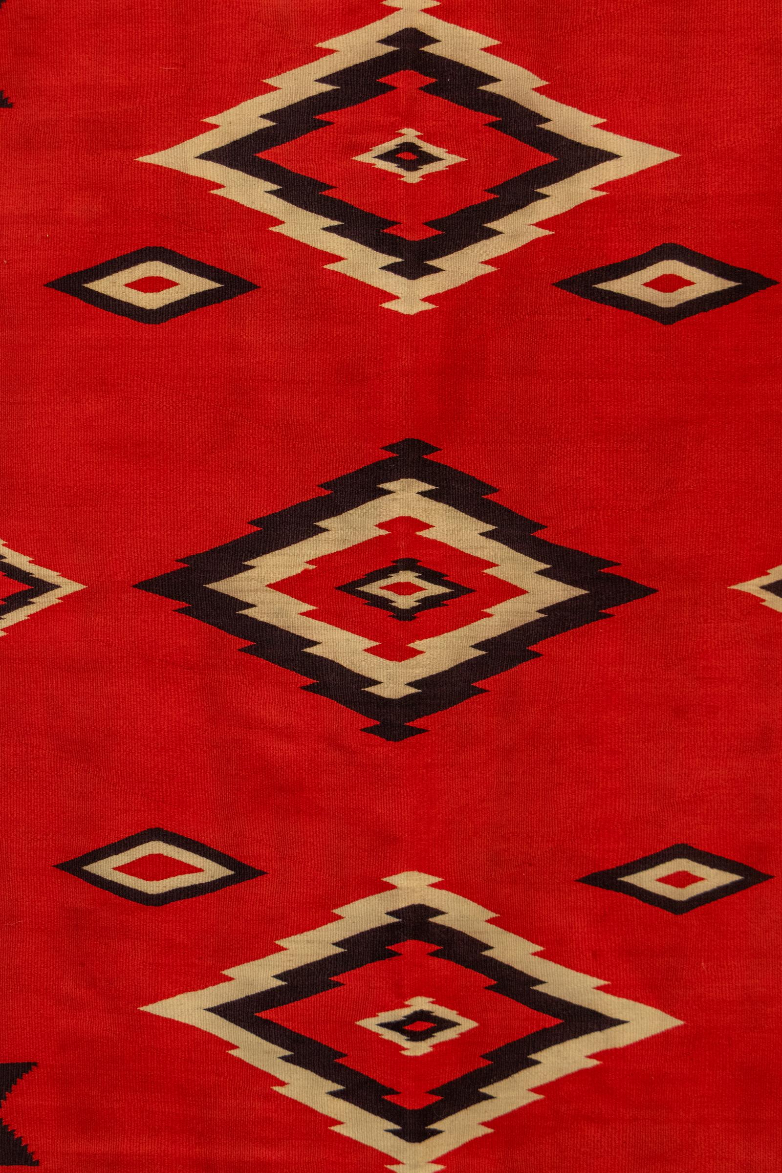 This exceptional 19th-century Navajo (Diné) serape textile, dating to circa 1890, is a remarkable example of Transitional Period weaving—bridging traditional Native American artistry with the evolving aesthetic influences of the late 19th century.