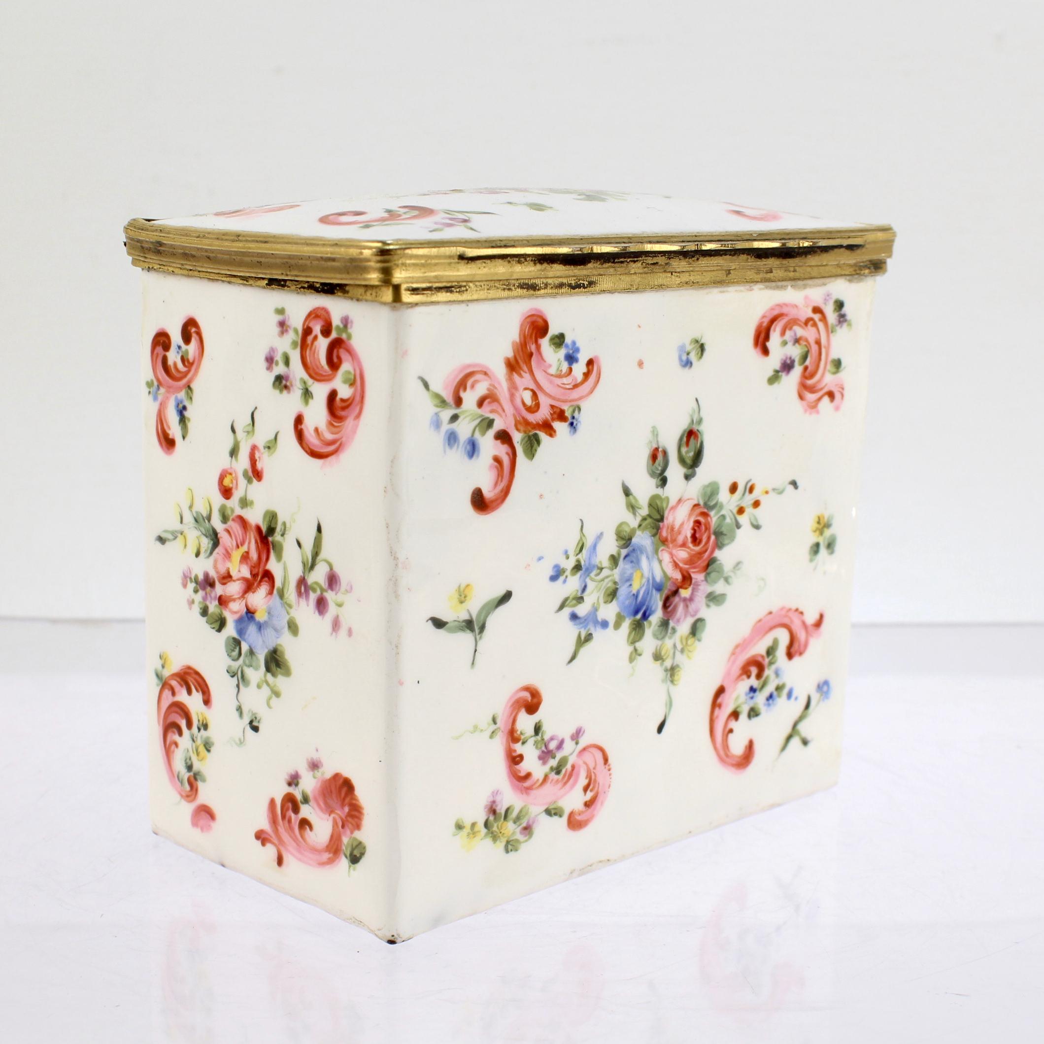 A fine antique enamel tea caddy.

With a gilt bronze mounted lid. 

In the South Staffordshire manner.

Decorated with floral sprays and rocaille swags to all sides. 

Likely French or made by the English for the French Market. 

Simply a