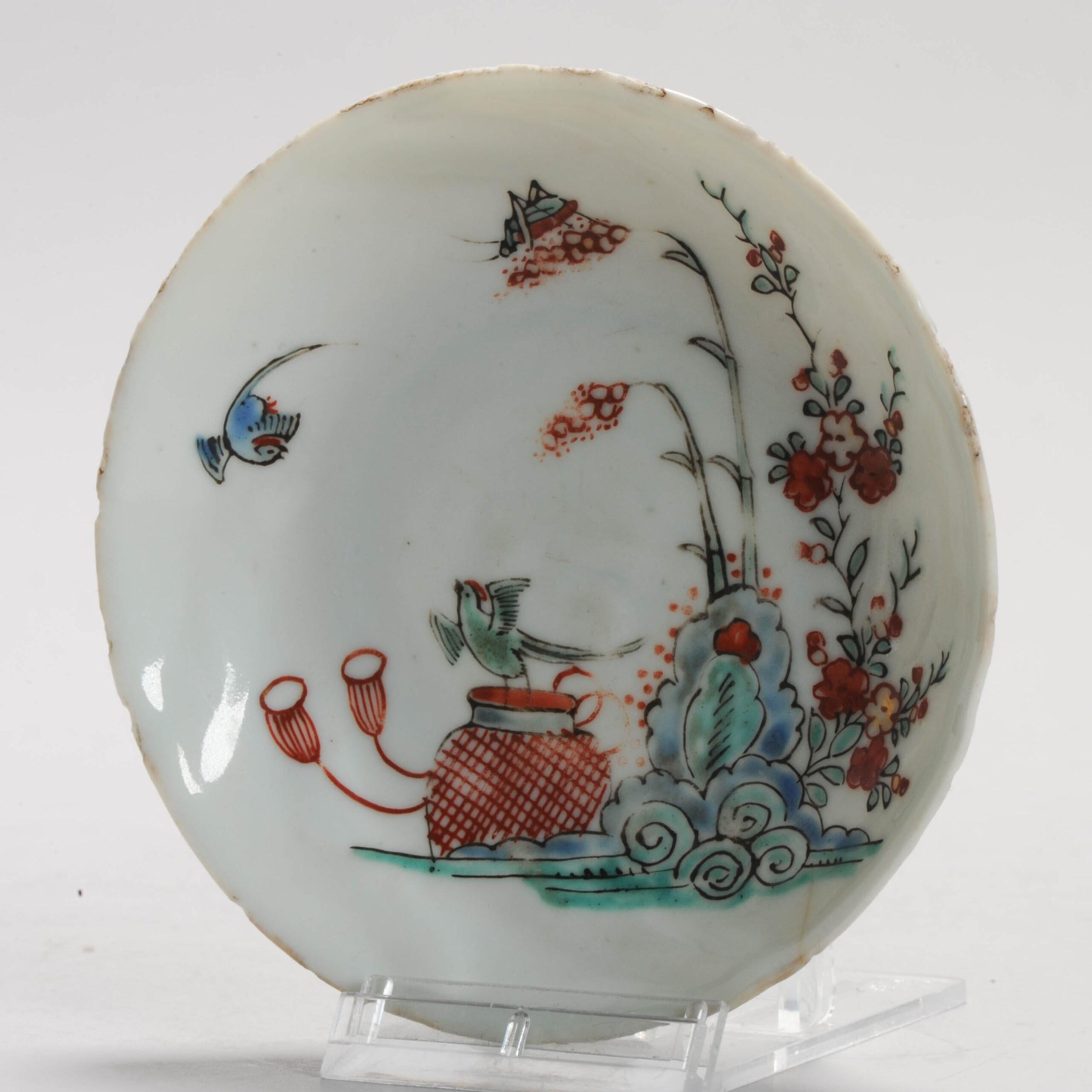 

Sharing with you this unusual Dutch Decorated Kakiemon Style saucer dish. The dish itself is a white porcelain plate from the Kangxi period, ca 1700-1720. The painting is Dutch Enamelling from ca 1710-1725. Visible is a scene in what seems to be a