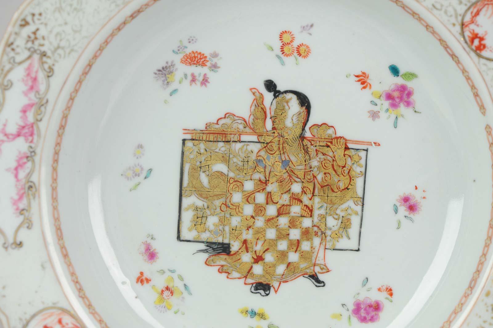A rare and quality painting plate. It's a chine de commande dish but unusual because the central painting is a Chinese person f a Chinese person with a Chinese person holding an artifact with a dragon in gilt. He is also holding a ruyi