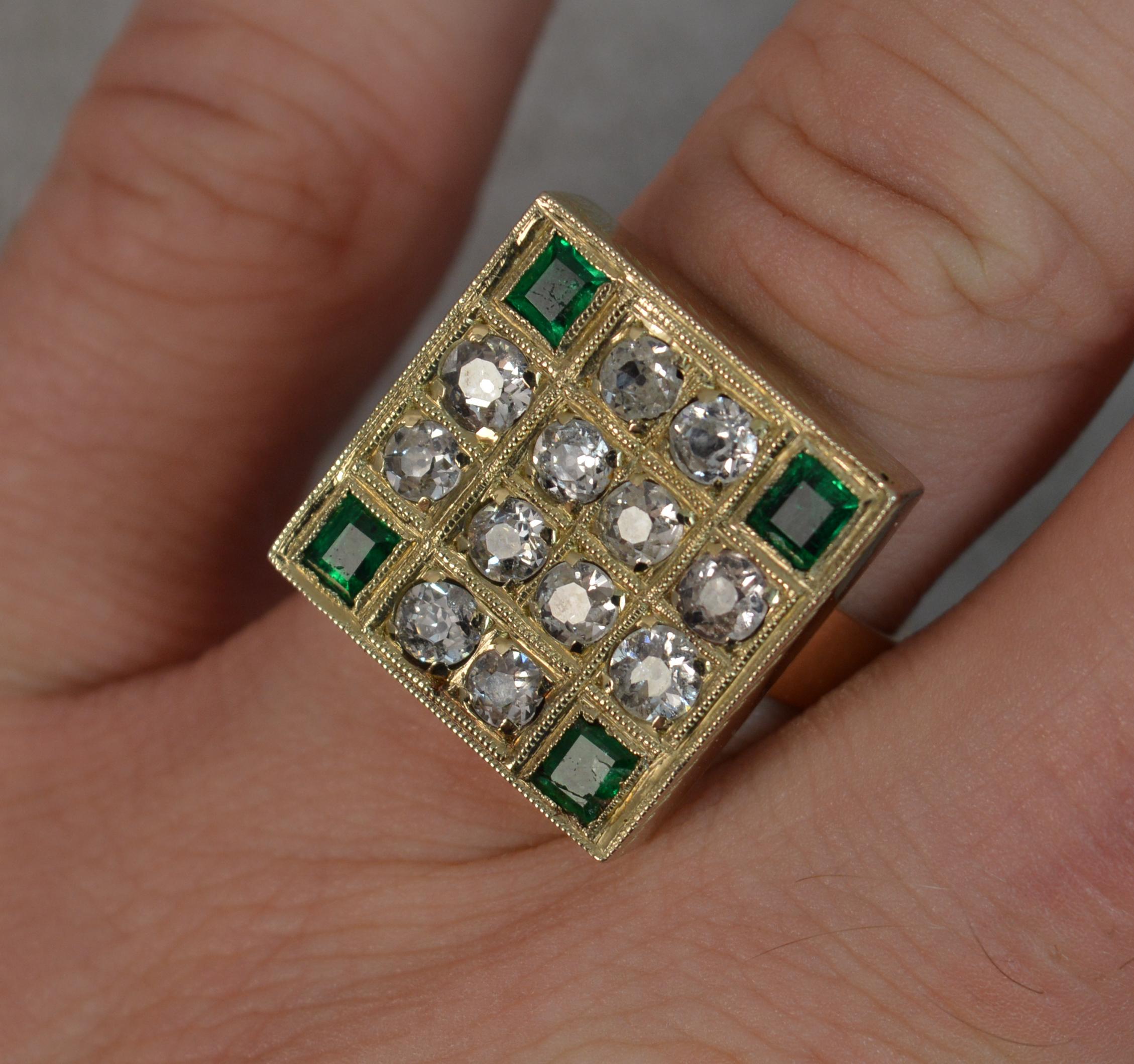 A stunning 18ct Gold, Diamond and Emerald statement ring.
A large square shaped cluster head, 17.5mm x 17.5mm.
Designed with twelve natural old cut diamonds to total approx 1.25 carats with a rectangular cut emerald to each corner.
Substantially