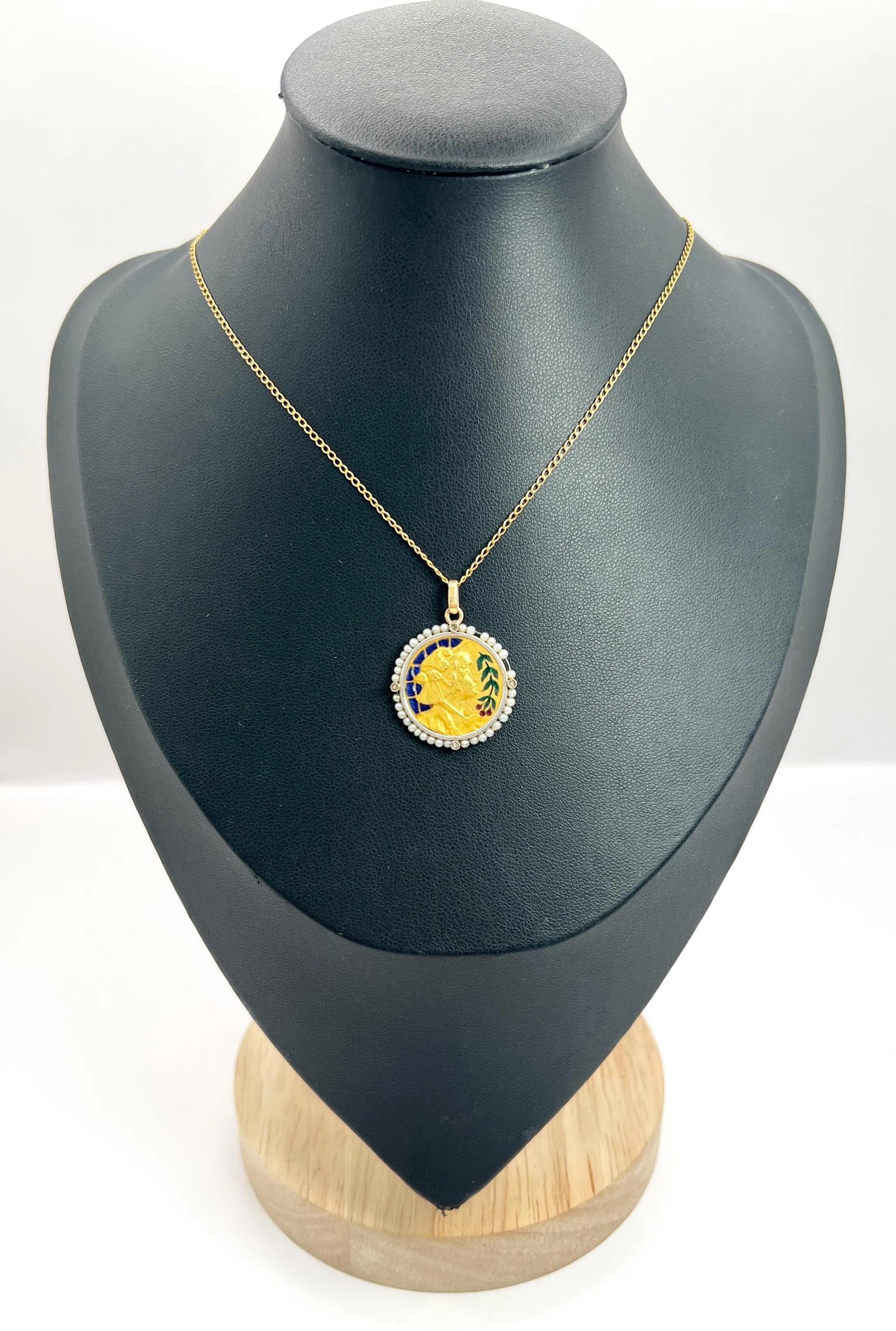 Antique Lady Pendant 

18ct Gold

Circa 1920s

This exquisite 18ct yellow gold Art Nouveau pendant is a stunning testament to the artistry of its time. At its centrepiece, a delicate portrait of a lady wearing an elegant bonnet is adorned with